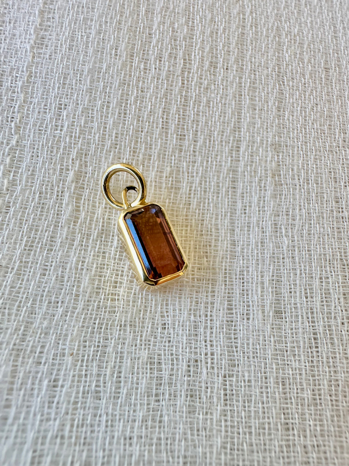 18K gold pink tourmaline charm with an emerald cut stone