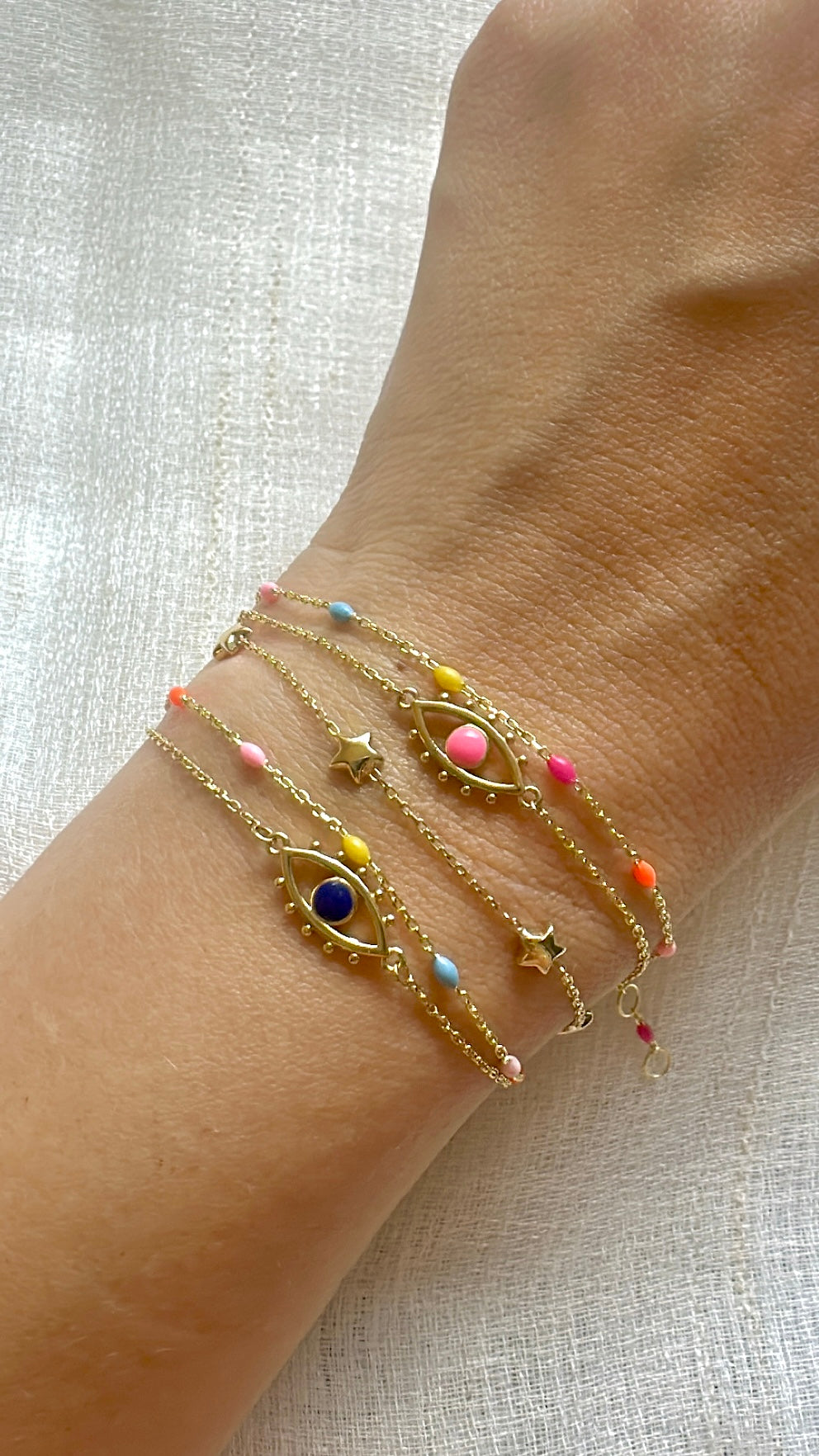 Dainty 18K gold enamel bead bracelet with beads spaced along the chain