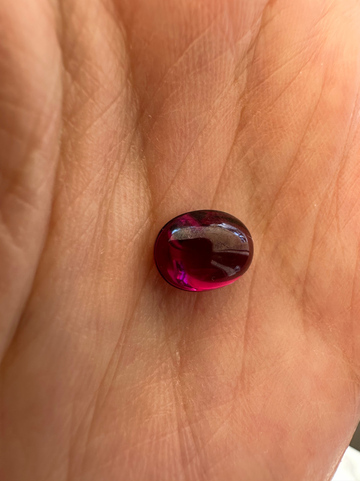 Purple garnet gemstone weighing 3.38 carats, listed as natural