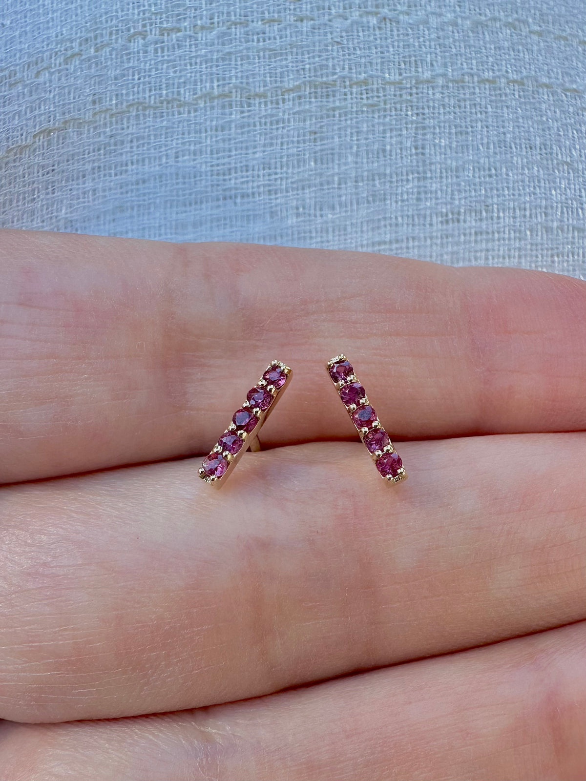 Ruby bar stud earring, a linear 18 karat gold design for everyday wear