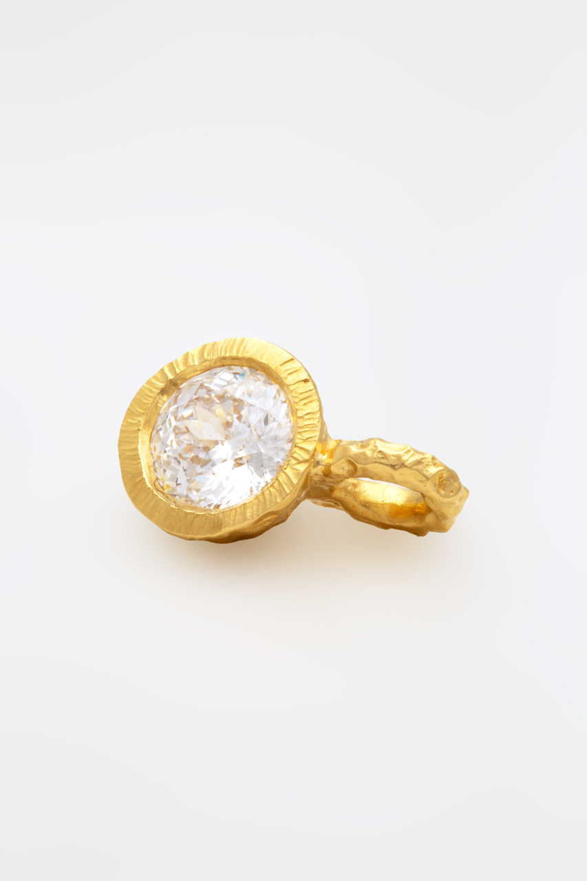 Glypto Diamond Pendant with a hand carved gold bail and large round diamond, on a white surface | Yasmin Nabulsi Fine Jewelry