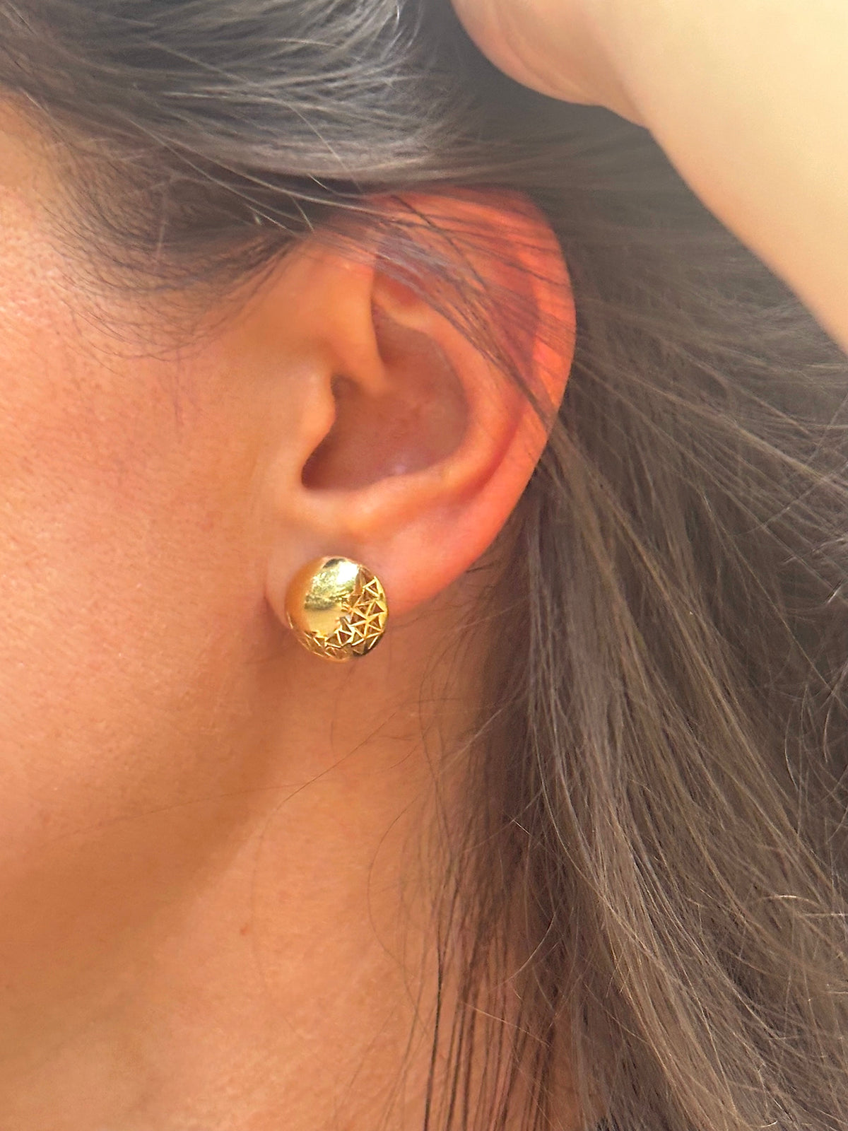 18K gold button earrings with geometric triangle cutouts and a domed surface | Yasmin Nabulsi Fine Jewelry