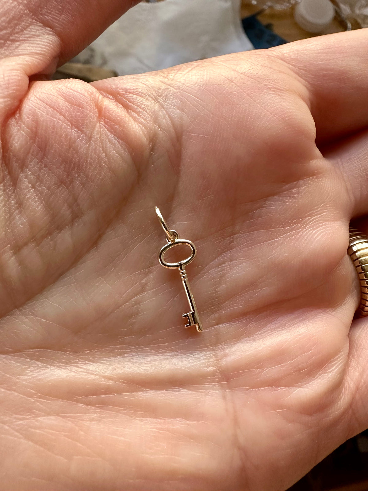 Gold key charm with a 4mm inside bail