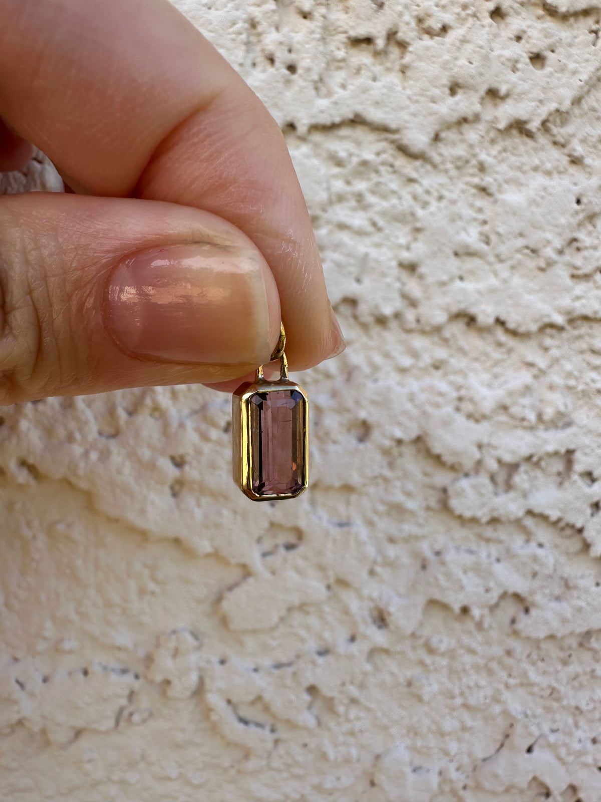 Gold tourmaline charm, a 2 carat pink emerald cut stone