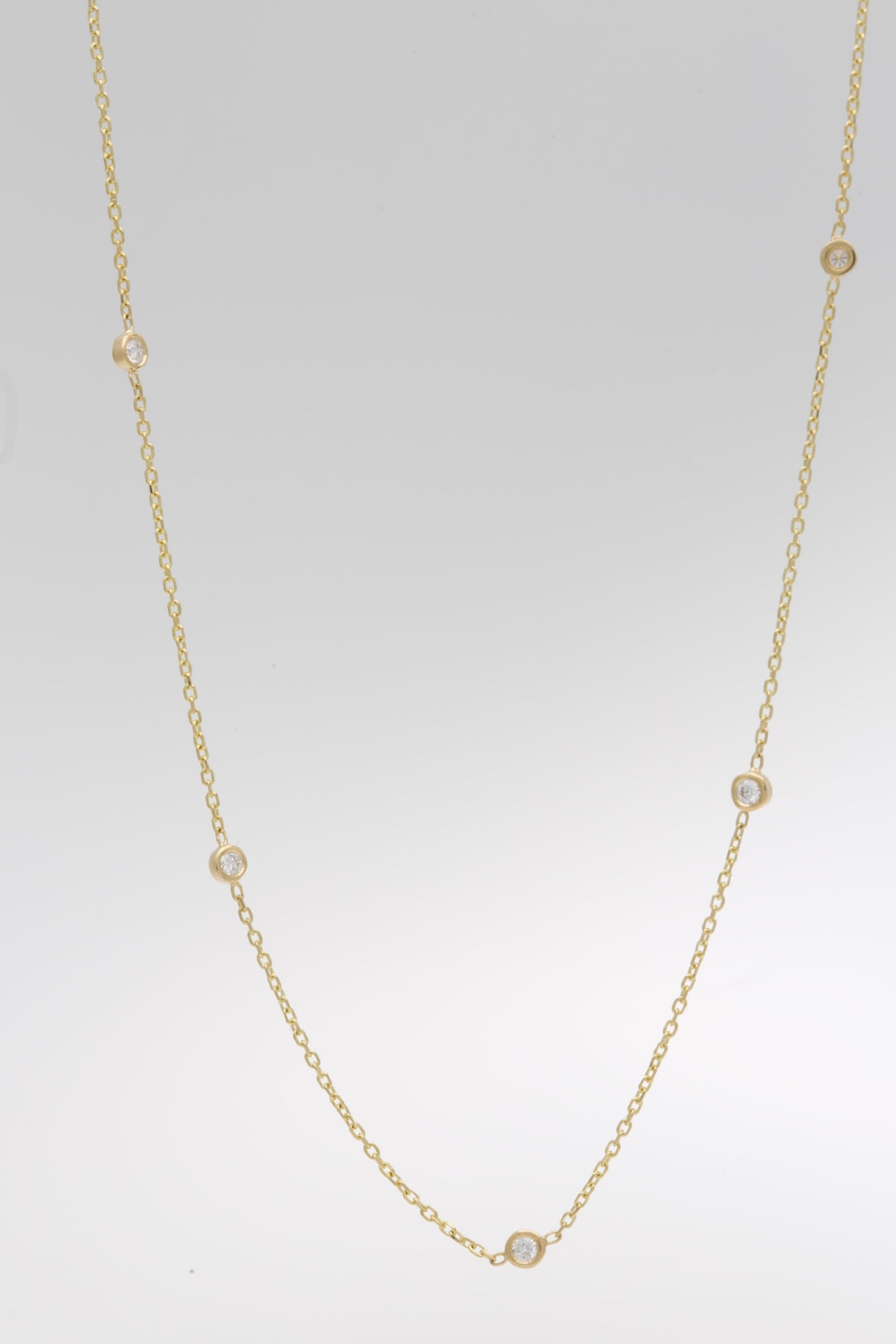 Dainty 18K gold station diamond necklace with five natural diamonds | Yasmin Nabulsi Fine Jewelry