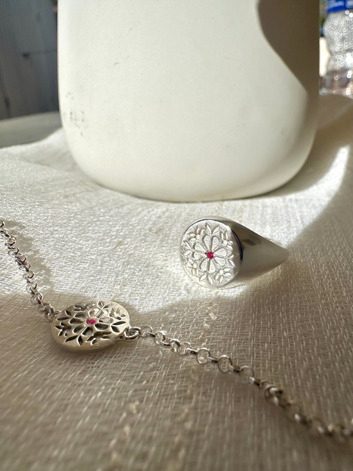 Engraved Tatreez charm on a rolo chain, shown from another angle