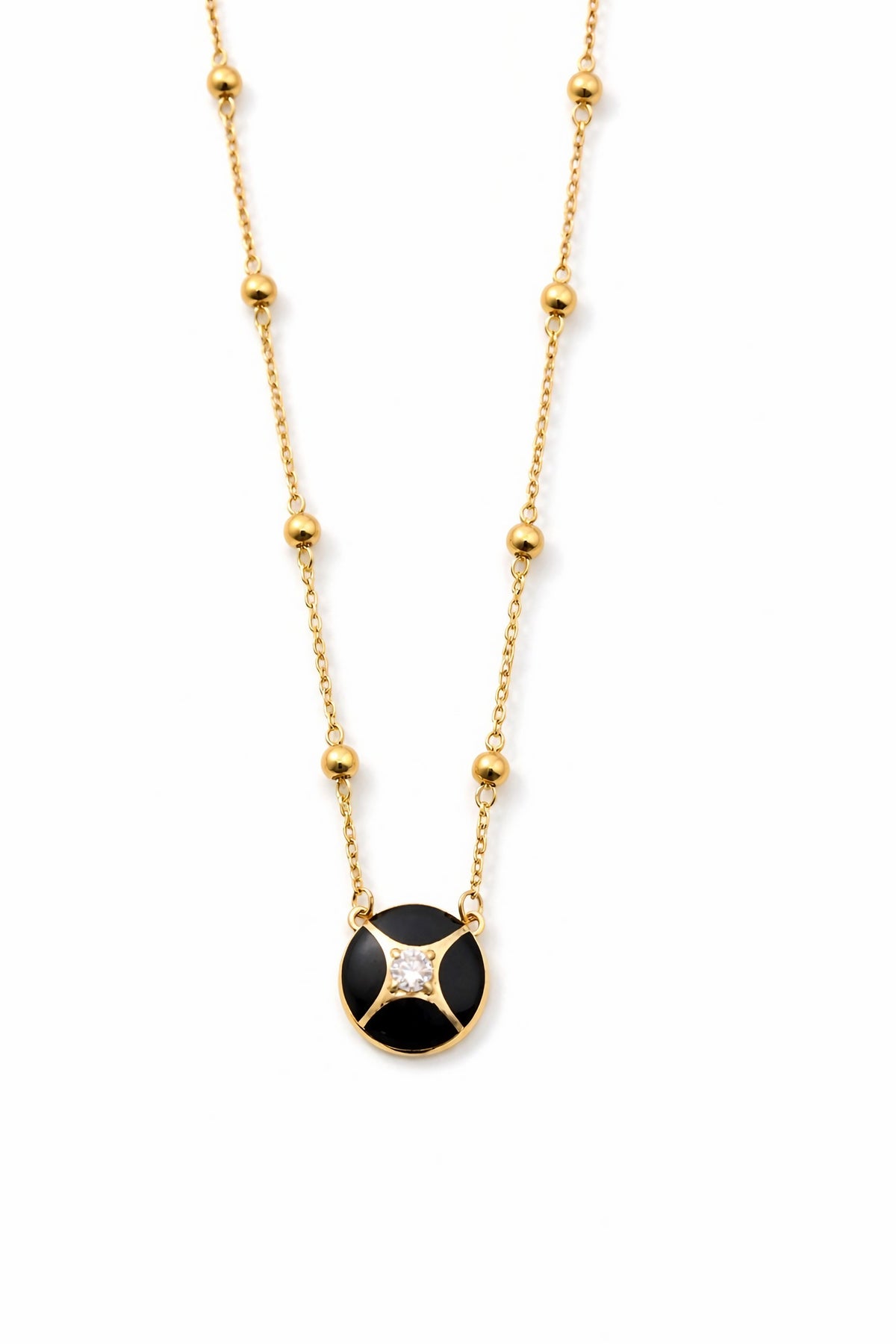 Round black enamel charm with a lab diamond set at its center on 18K gold