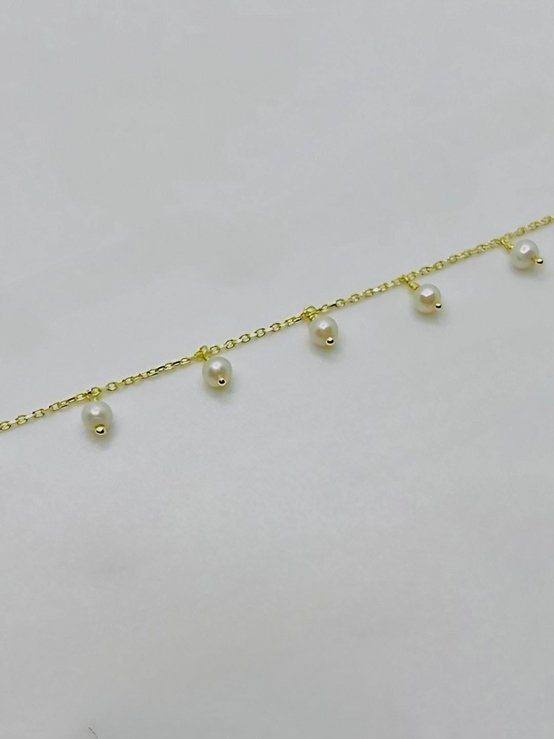 Gold anklet with dangling pearls, available in small, medium and large