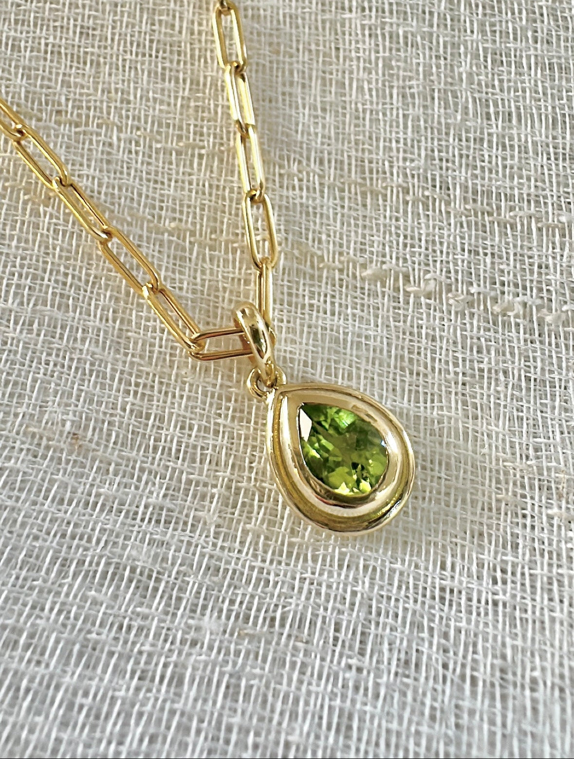 Peridot pendant in a two tiered gold bezel that matches the pear shape of the stone | Yasmin Nabulsi Fine Jewelry