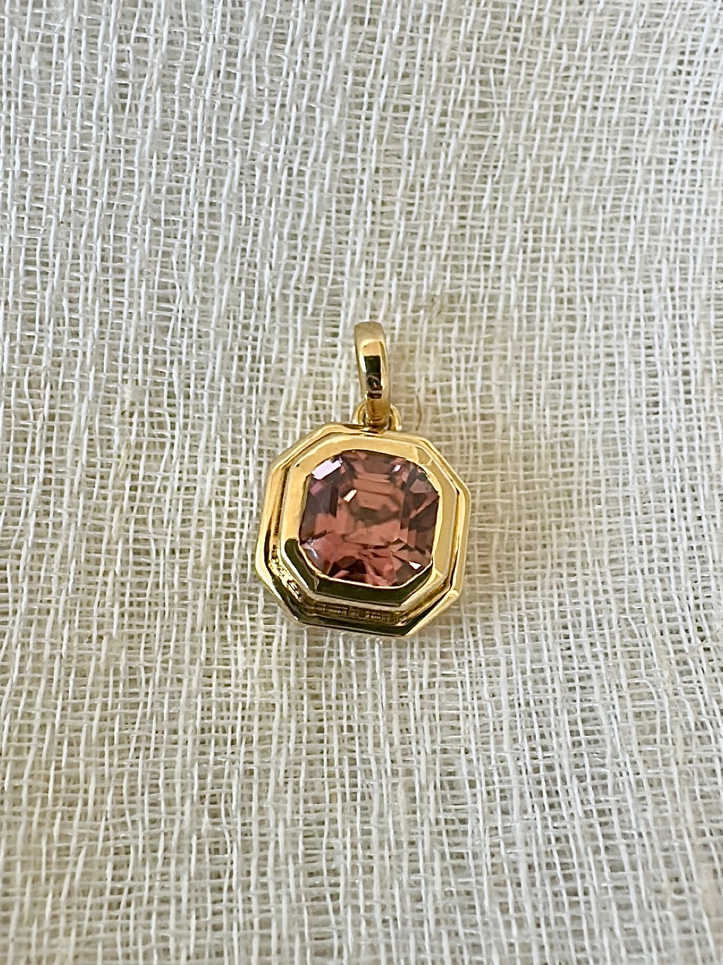 Pink zircon pendant in a custom two-tiered 18K gold bezel matching the hexagon stone
