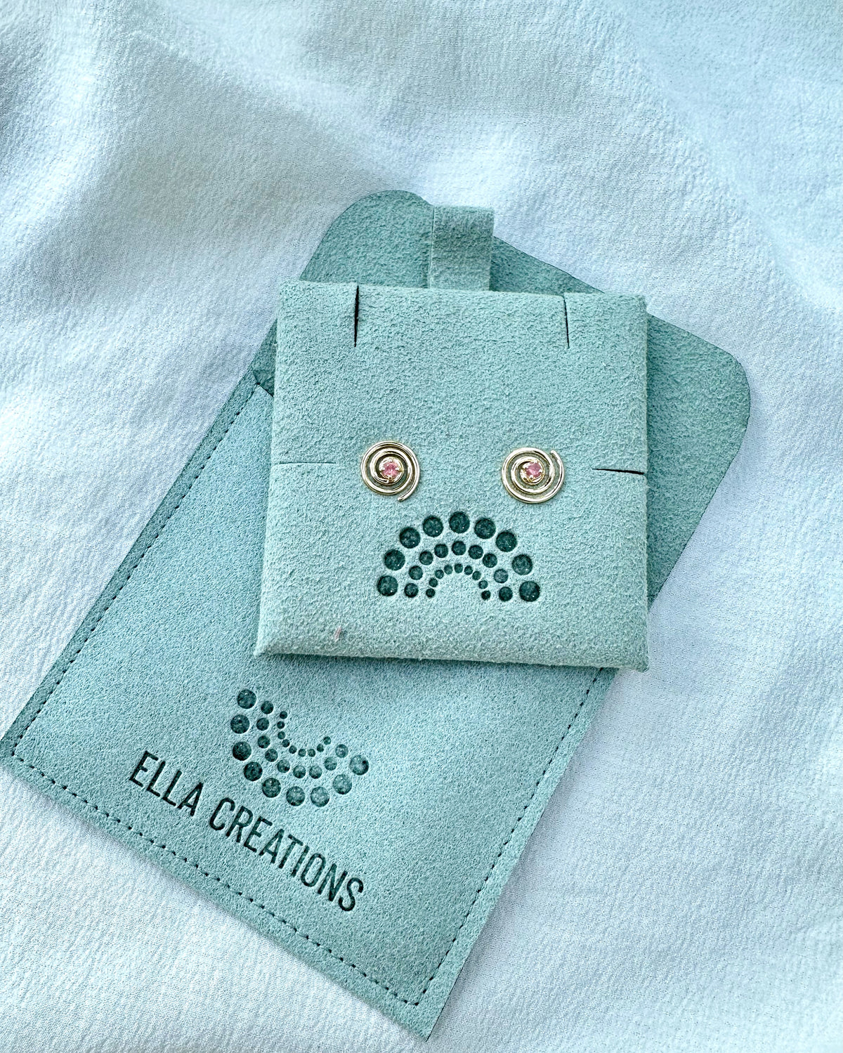 Minimalistic pink sapphire studs in yellow gold, shown from another angle