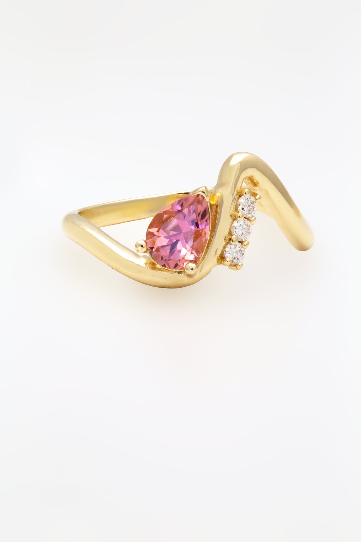 14K wave ring with a pear shaped center stone in a prong setting | Yasmin Nabulsi Fine Jewelry