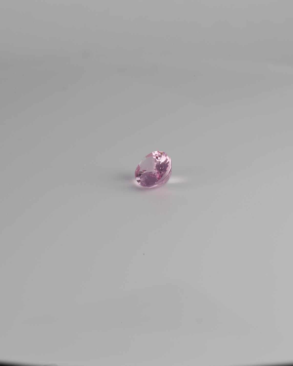 Pink spinel oval gemstone shown at a 300 degree angle