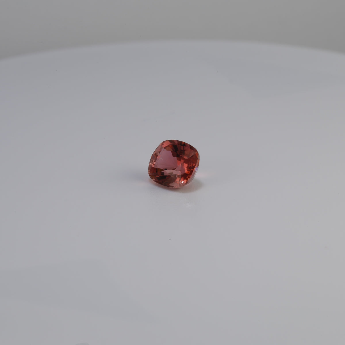 Cushion cut pinkish peach tourmaline, 1.42 carat gemstone, square angle view