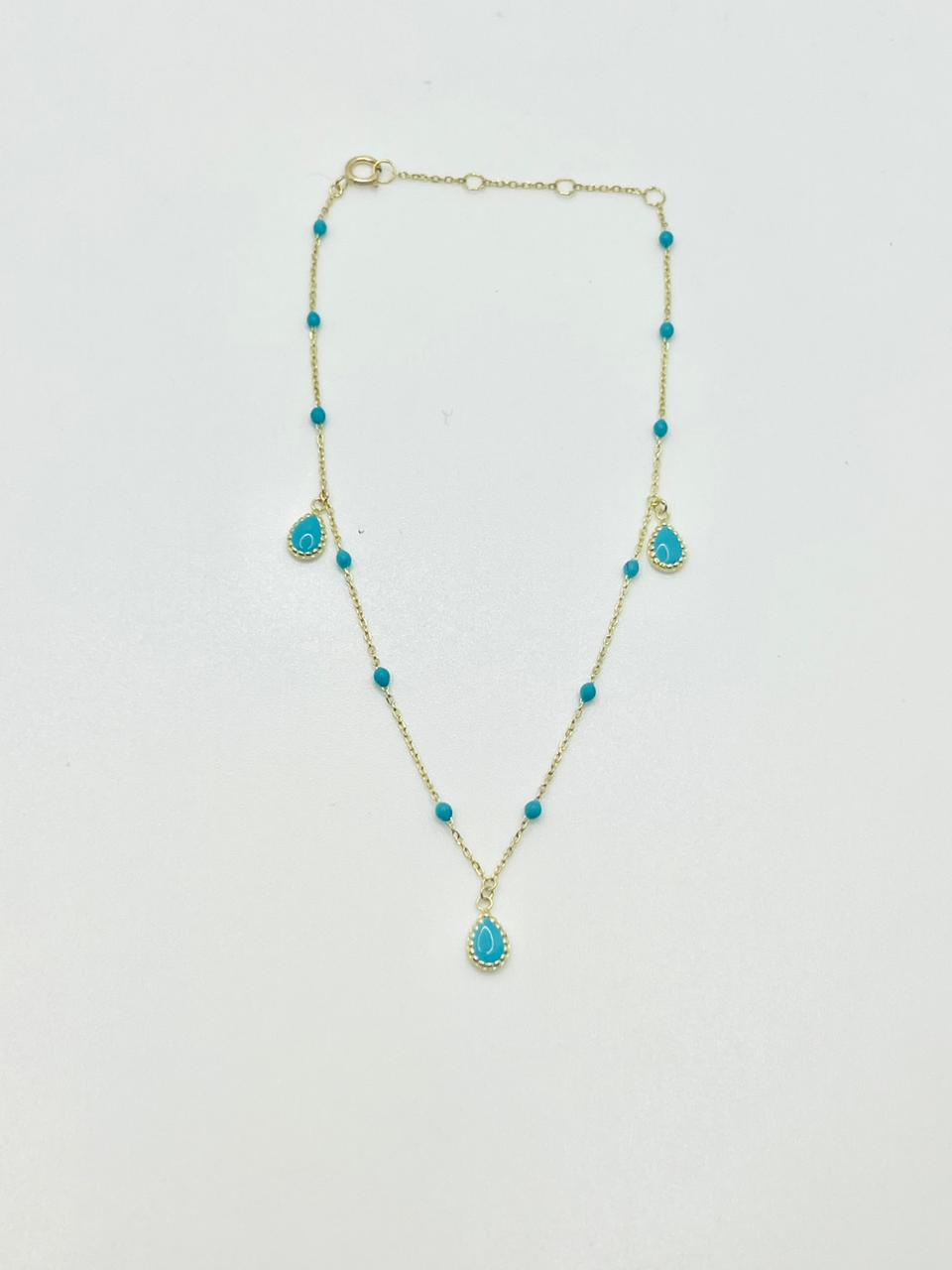 Gold anklet with enamel teardrop charms shown from a second angle