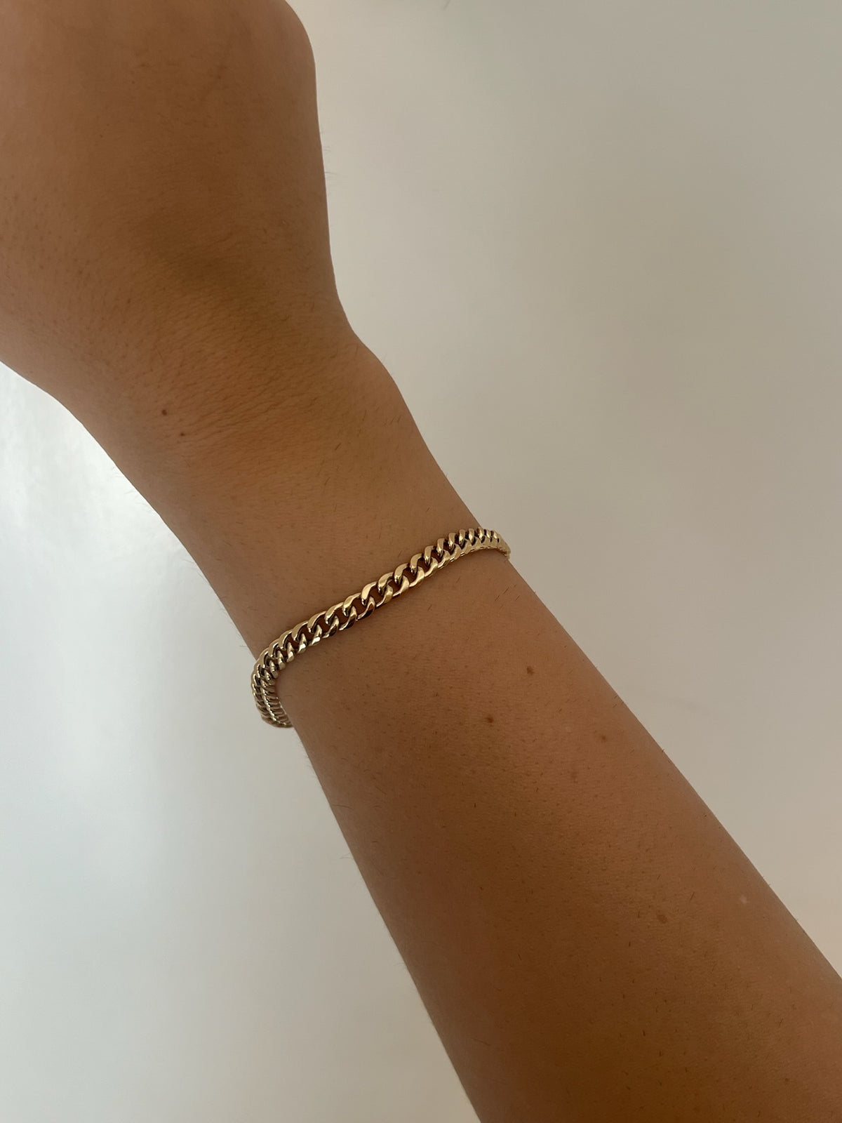 18K gold Cuban link chain bracelet with a lobster clasp, fourth view