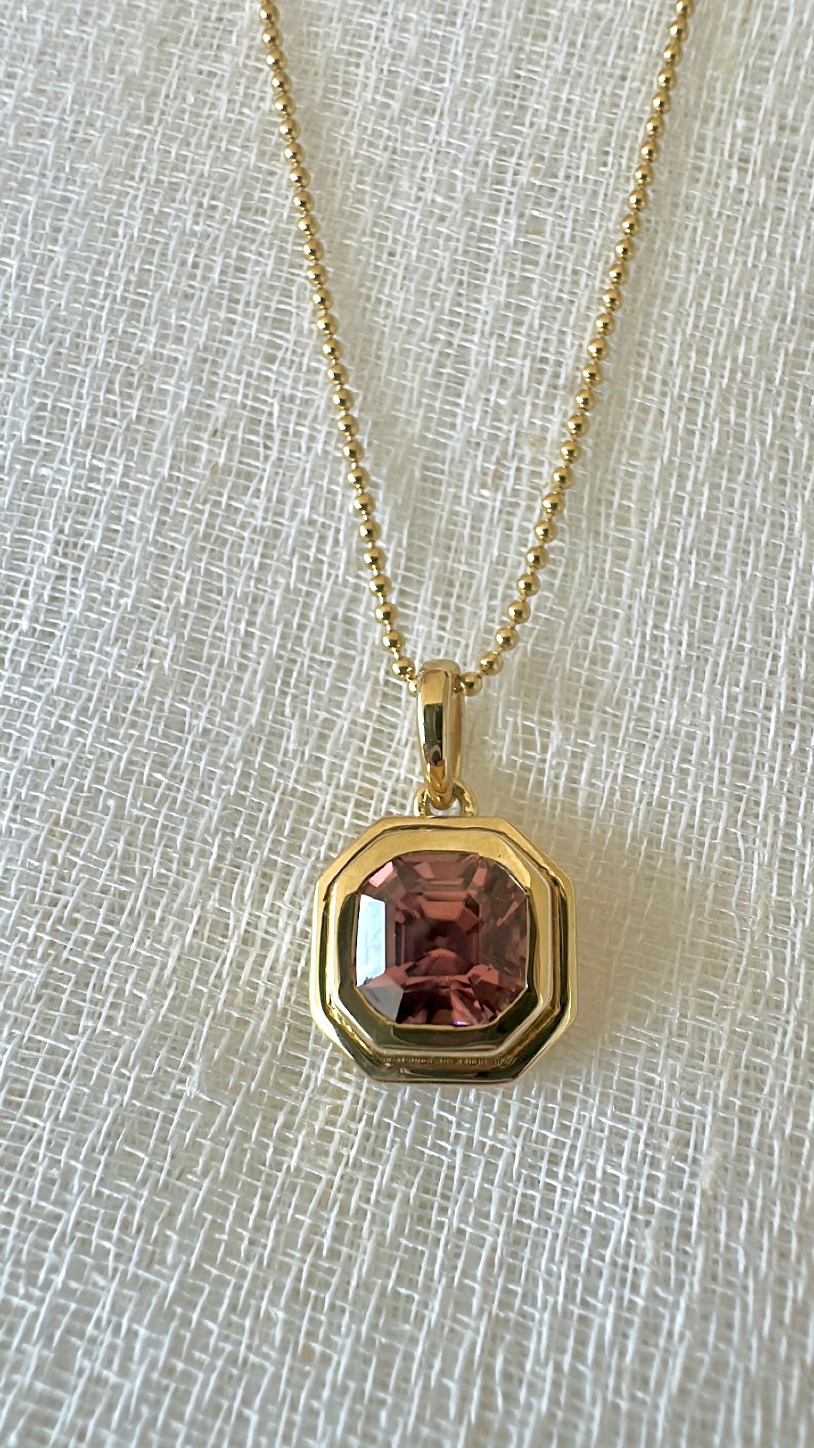 December birthstone pink zircon pendant with an open back to show the stone color