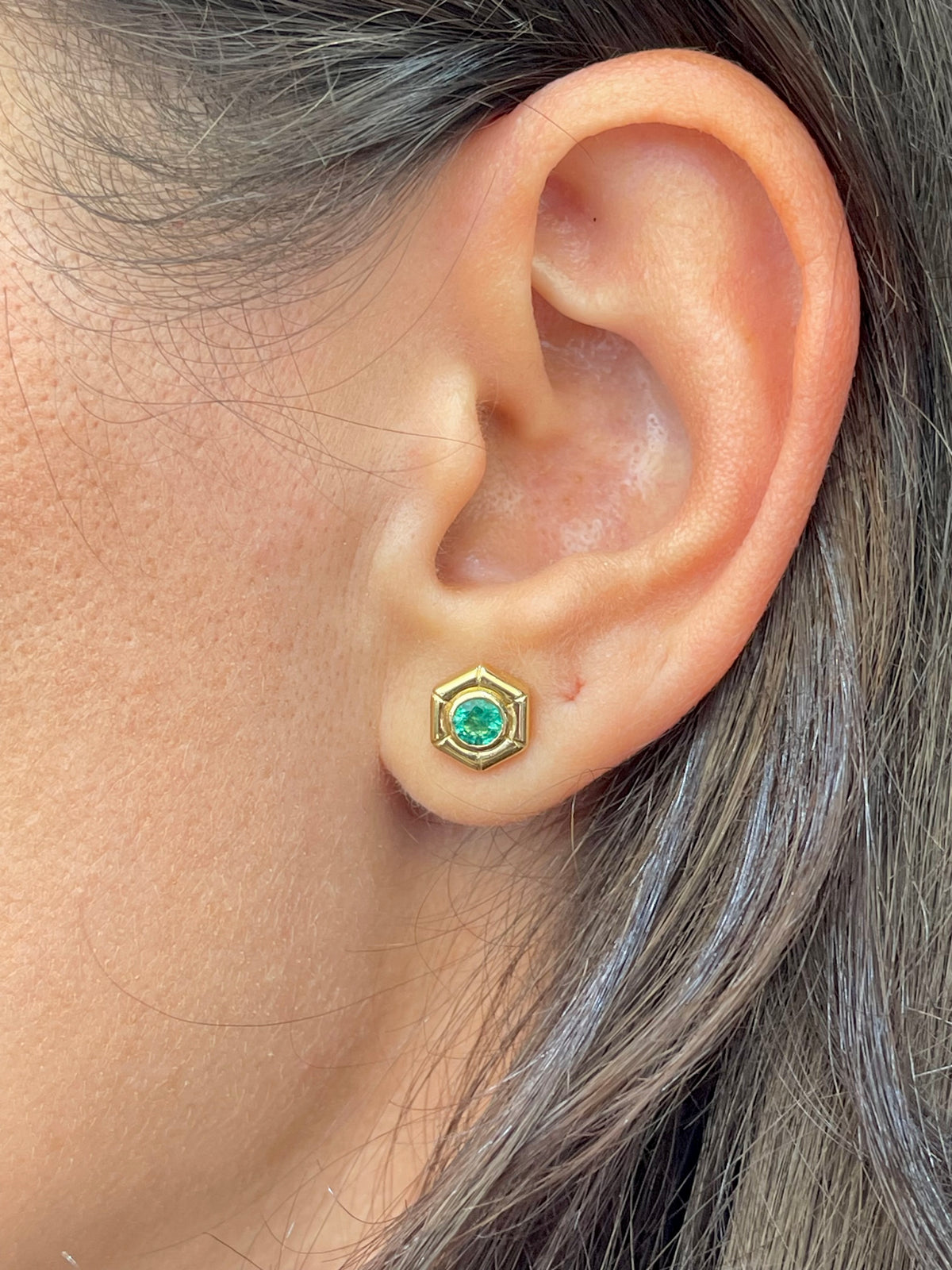 Emerald stud earrings measuring 7.86mm, 0.3 inch, in 18K gold