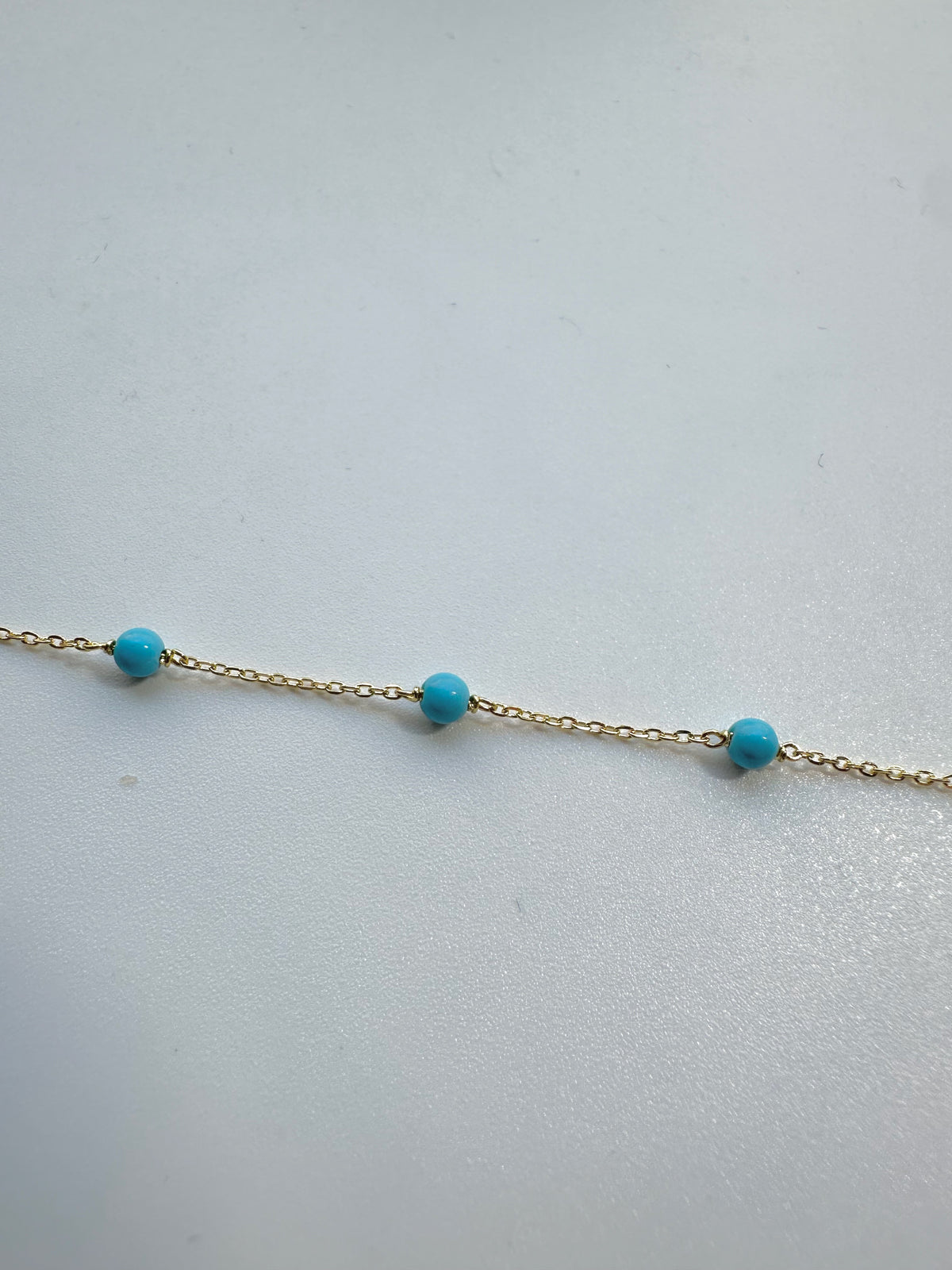 Gold chain bracelet with turquoise beads, 7 inches long