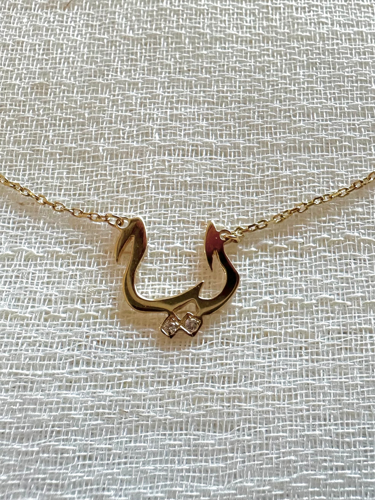 Arabic calligraphy nameplate in solid 18K gold, about 0.6 inch wide for a 3-letter name