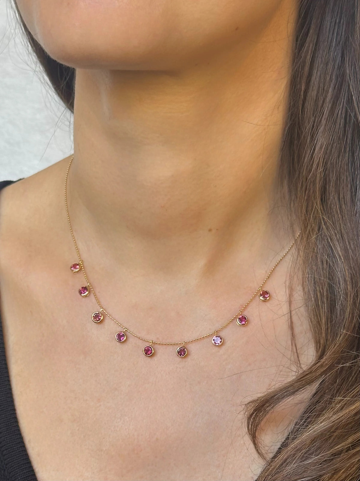 Nine natural pink tourmalines bezel set in solid 18K gold on a dainty drop necklace | Yasmin Nabulsi Fine Jewelry