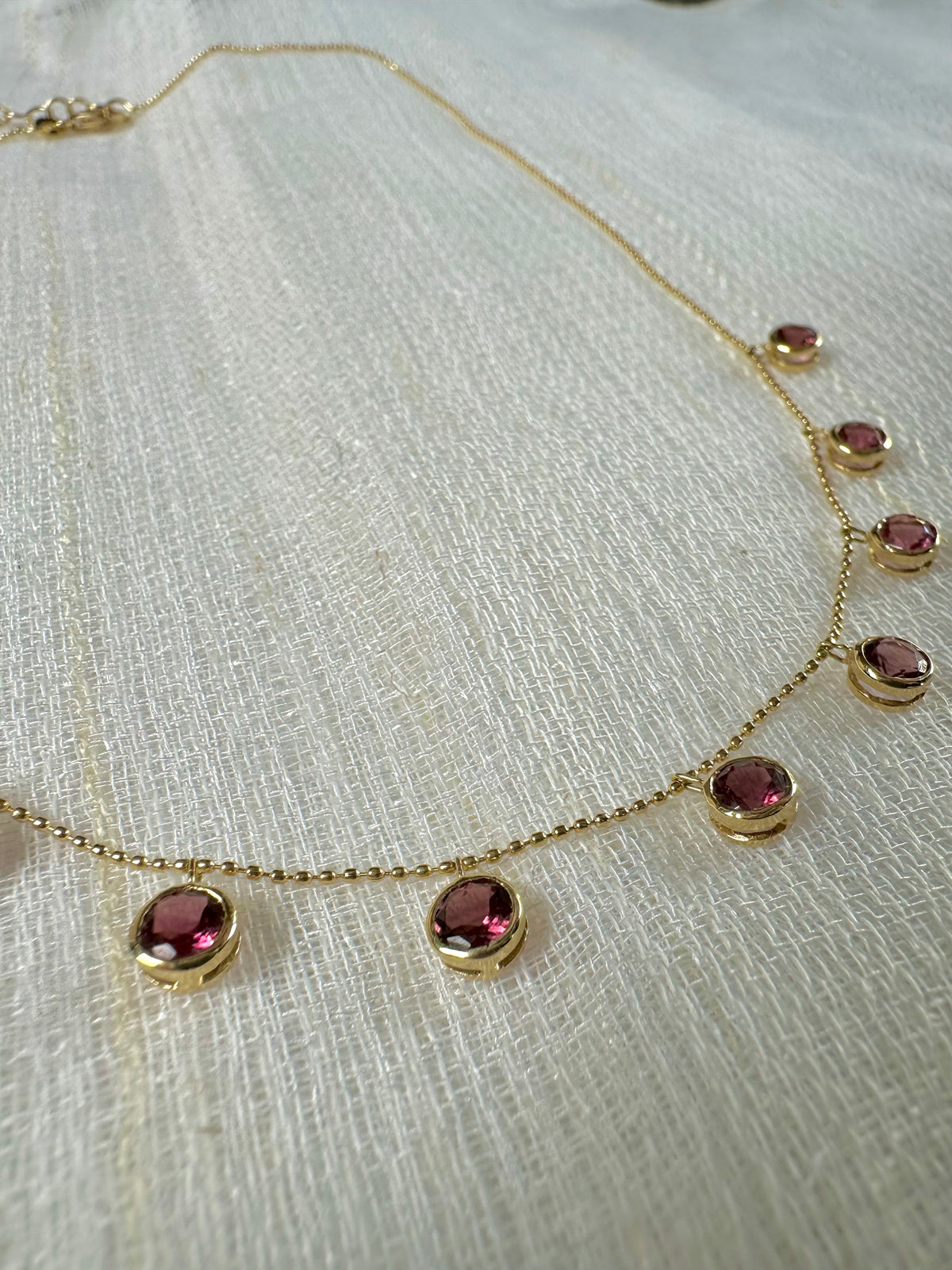 Adjustable 18K gold chain with a 2 inch extender on a pink tourmaline necklace
