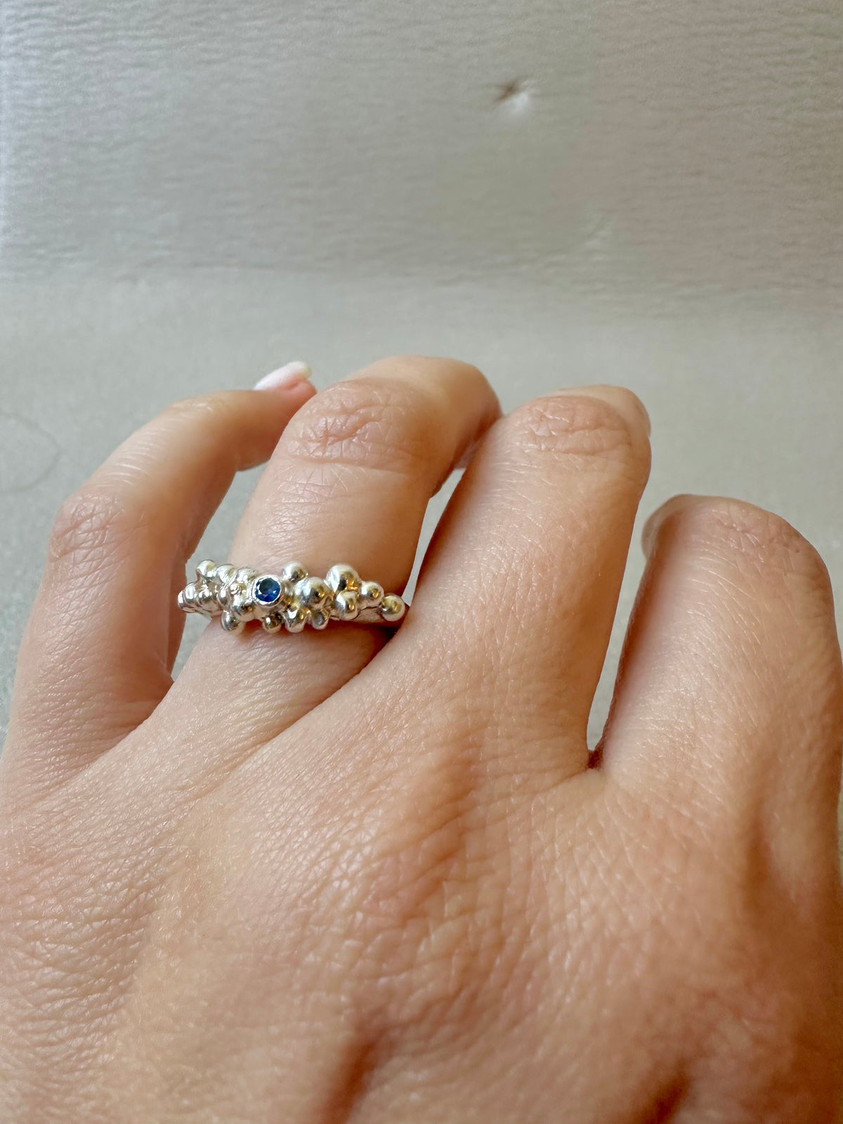 Blue sapphire bezel set ring in sterling silver with a 2.2mm round sapphire