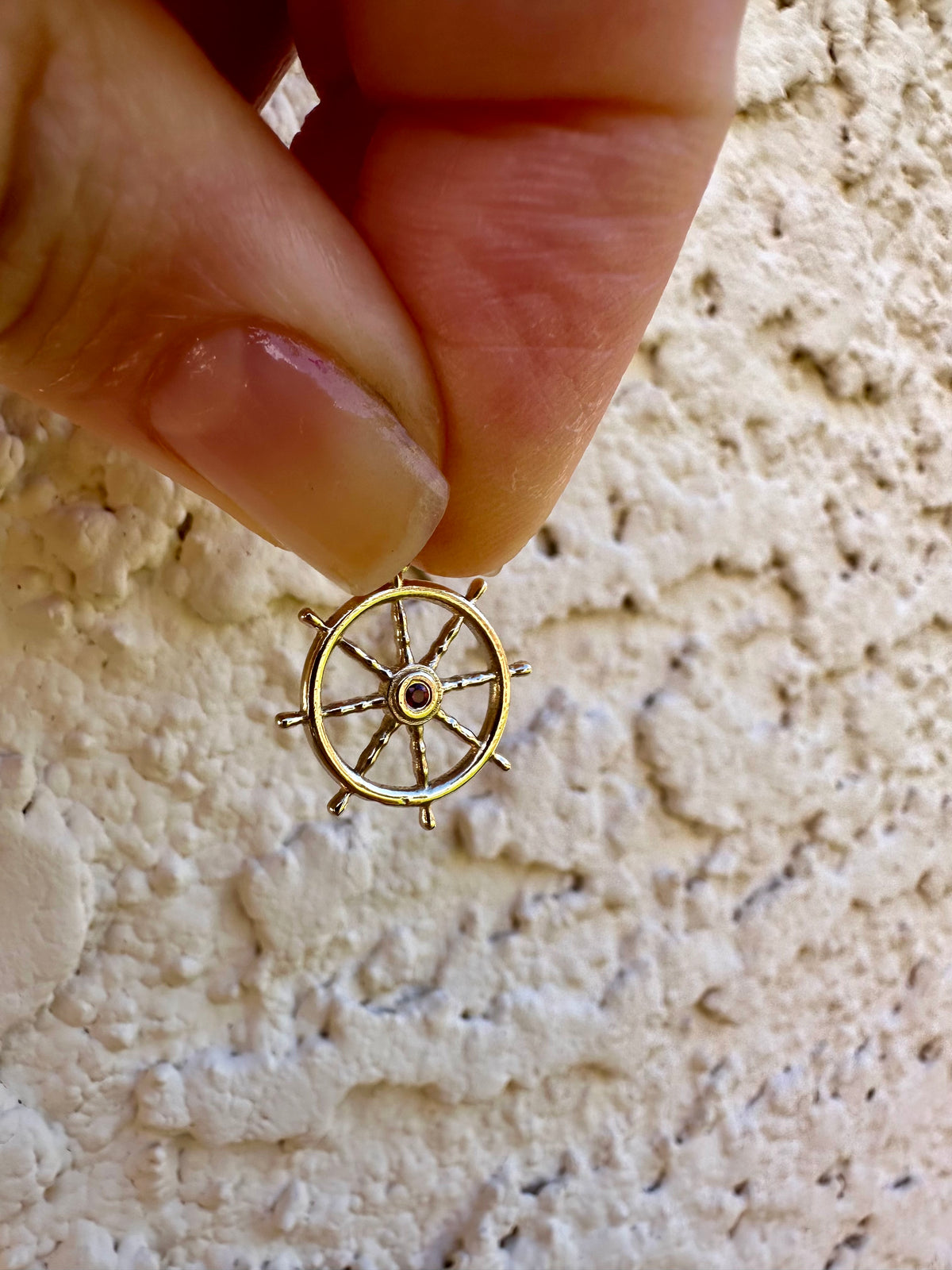 14K gold anchor wheel charm with a 2mm ruby | Yasmin Nabulsi Fine Jewelry