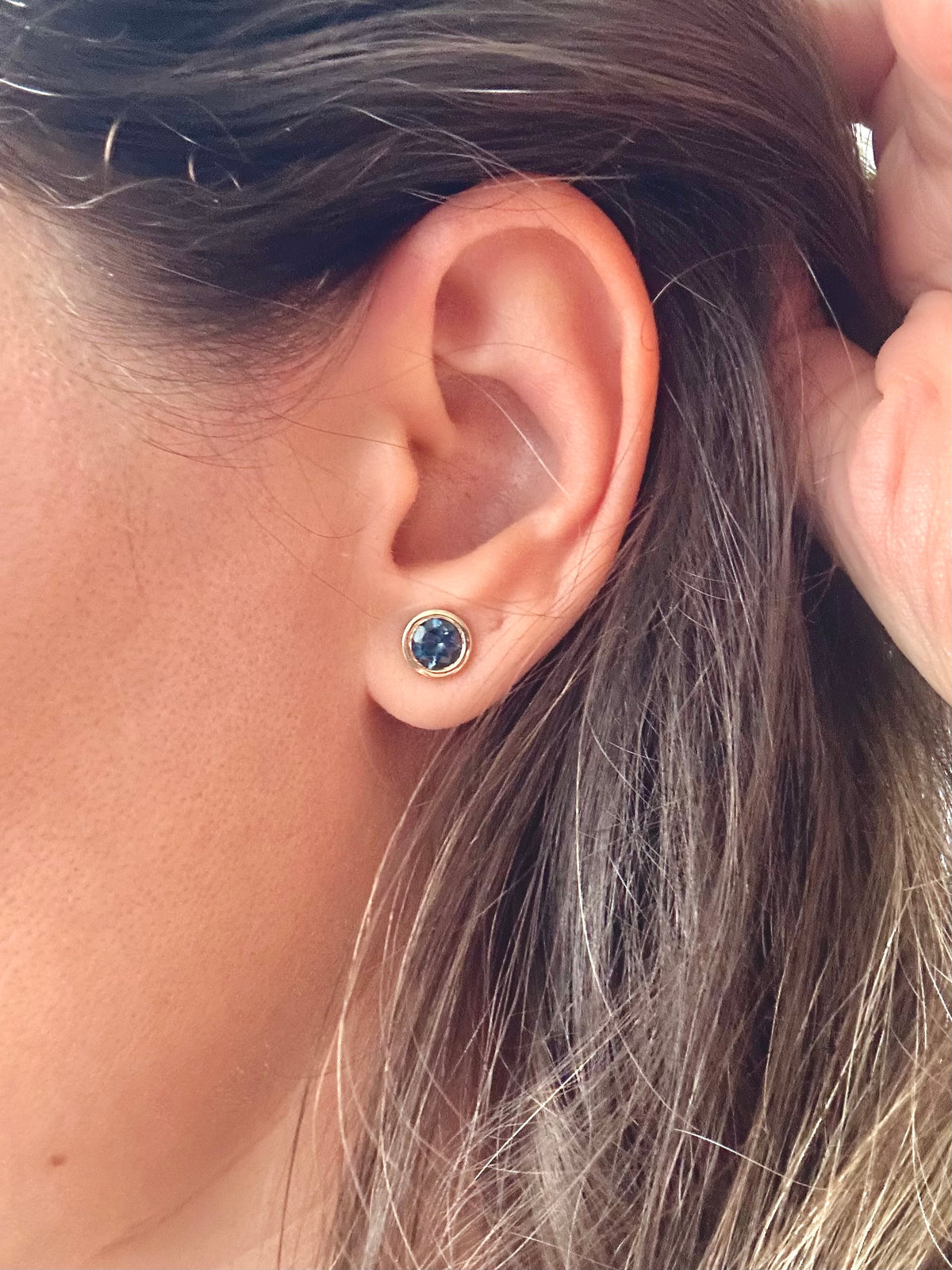 Round blue topaz earrings, a further view of the 18K gold bezel