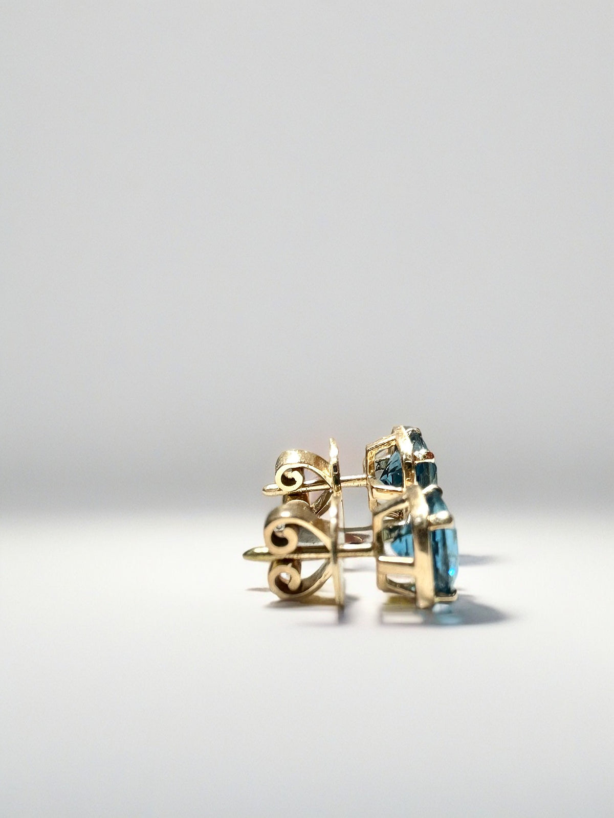 London blue topaz stud earrings with a mixed bezel and prong setting