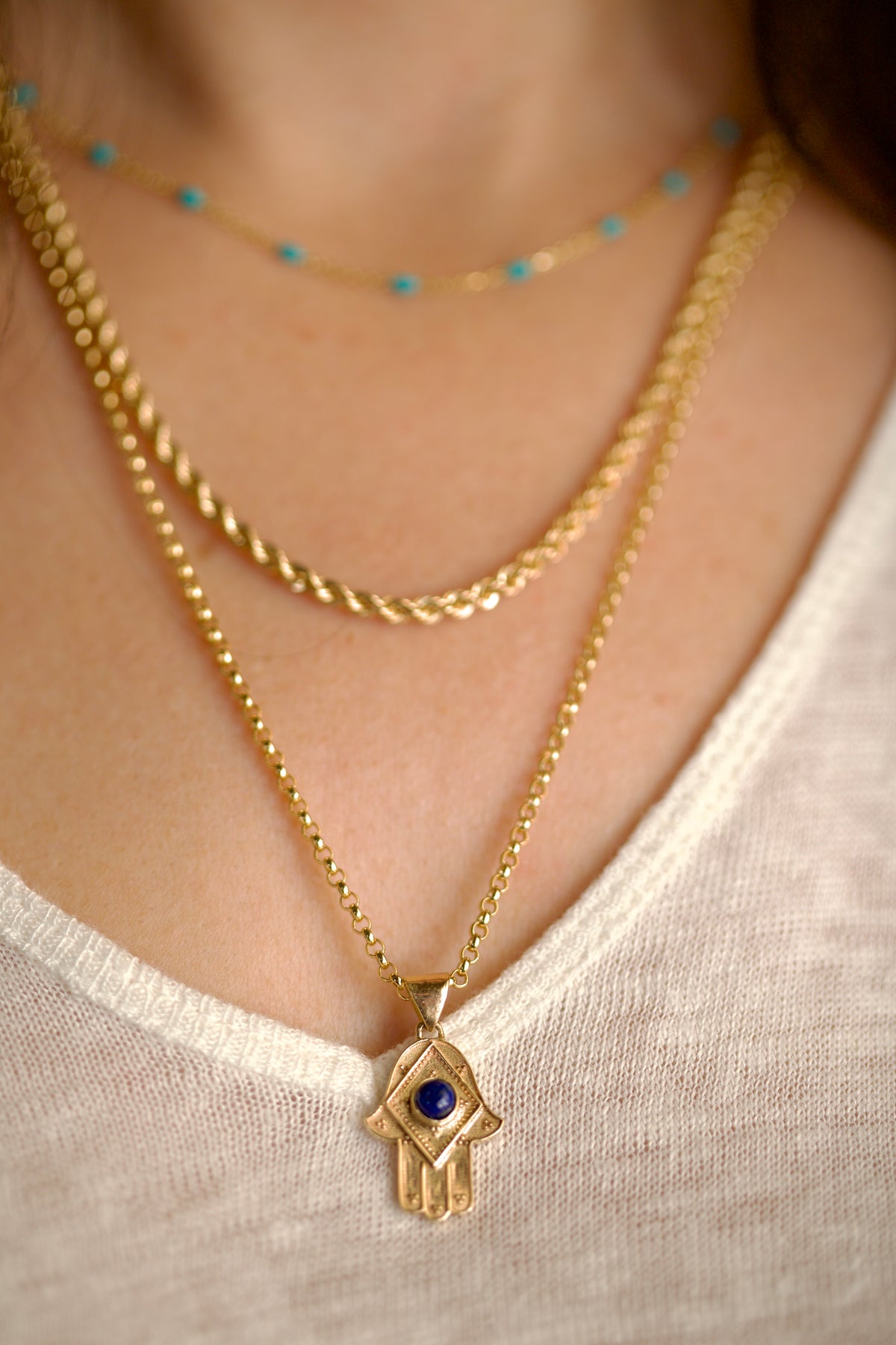 Lapis lazuli hamsa pendant measuring 20 by 15mm