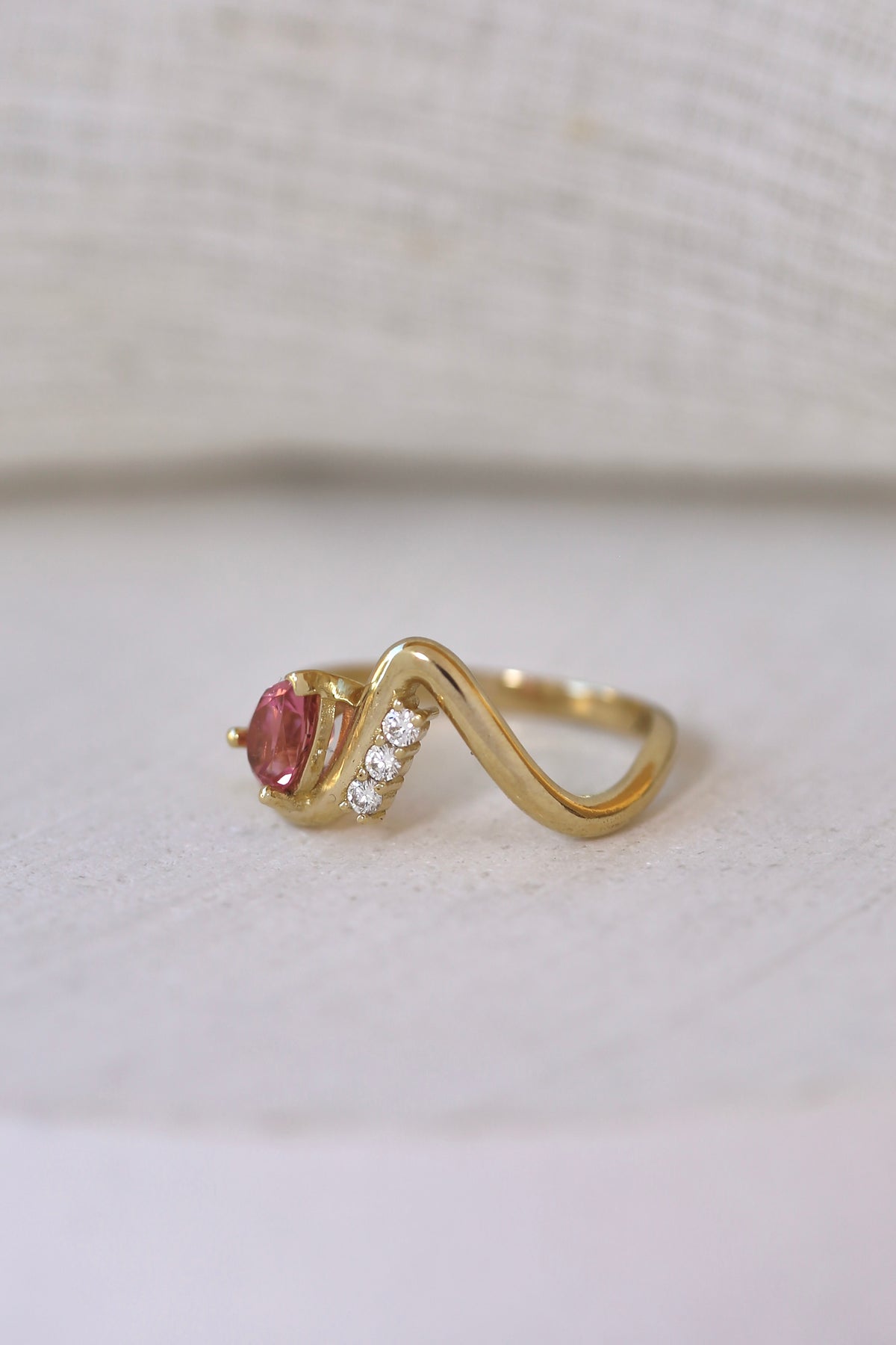 Flowing 14K gold wave ring that wraps around the finger
