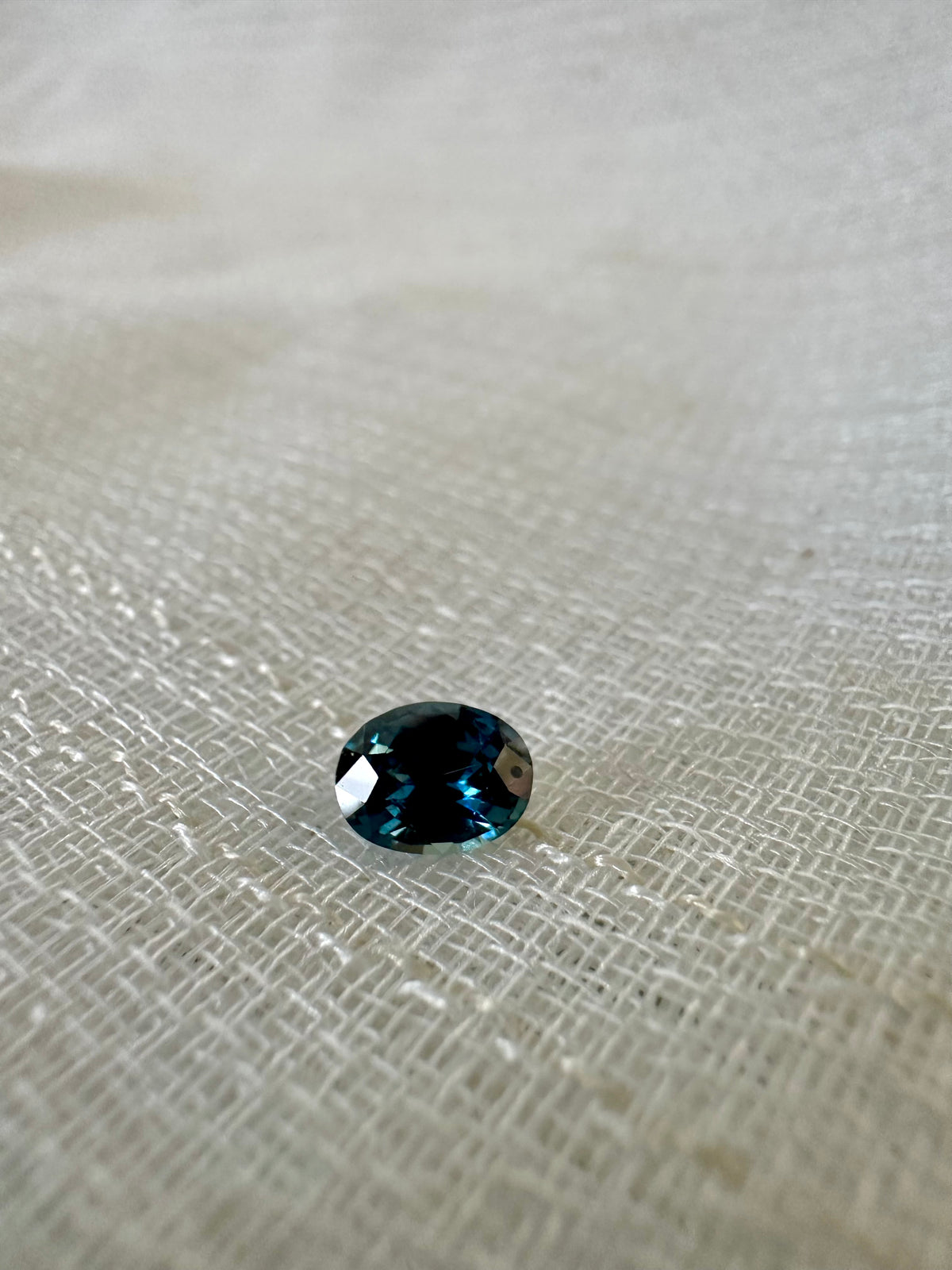 Unheated teal sapphire, mixed oval, shown from a different angle