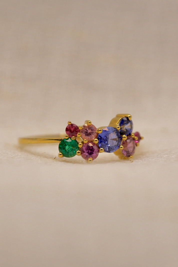 Natural multicolor sapphires and a small emerald in a cluster setting, third view