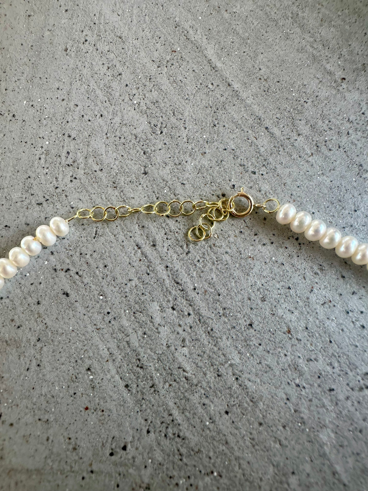Dainty pearl necklace, sixth view, with seven gold beads on the strand