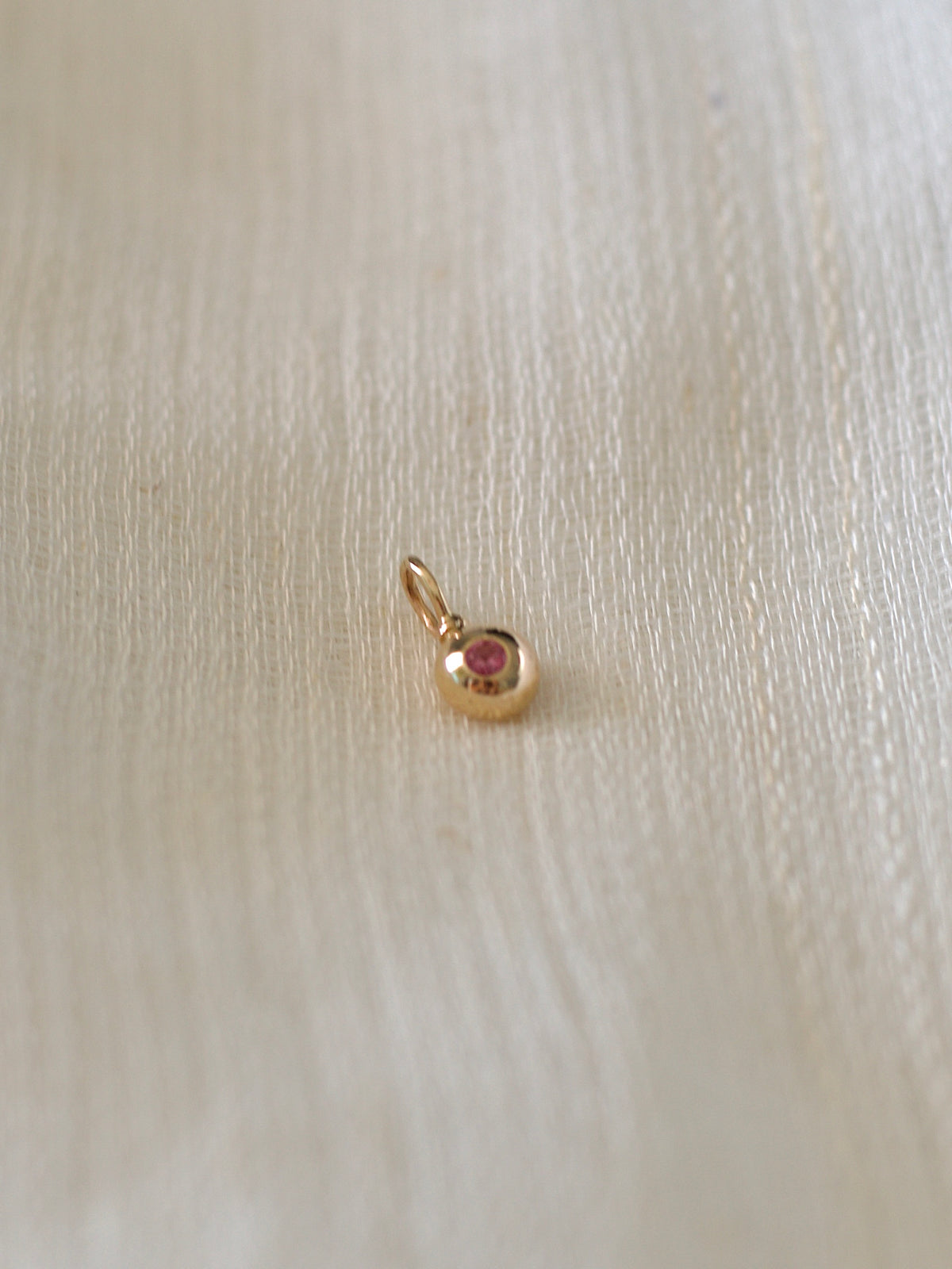 Pink sapphire charm in 14K gold, second view