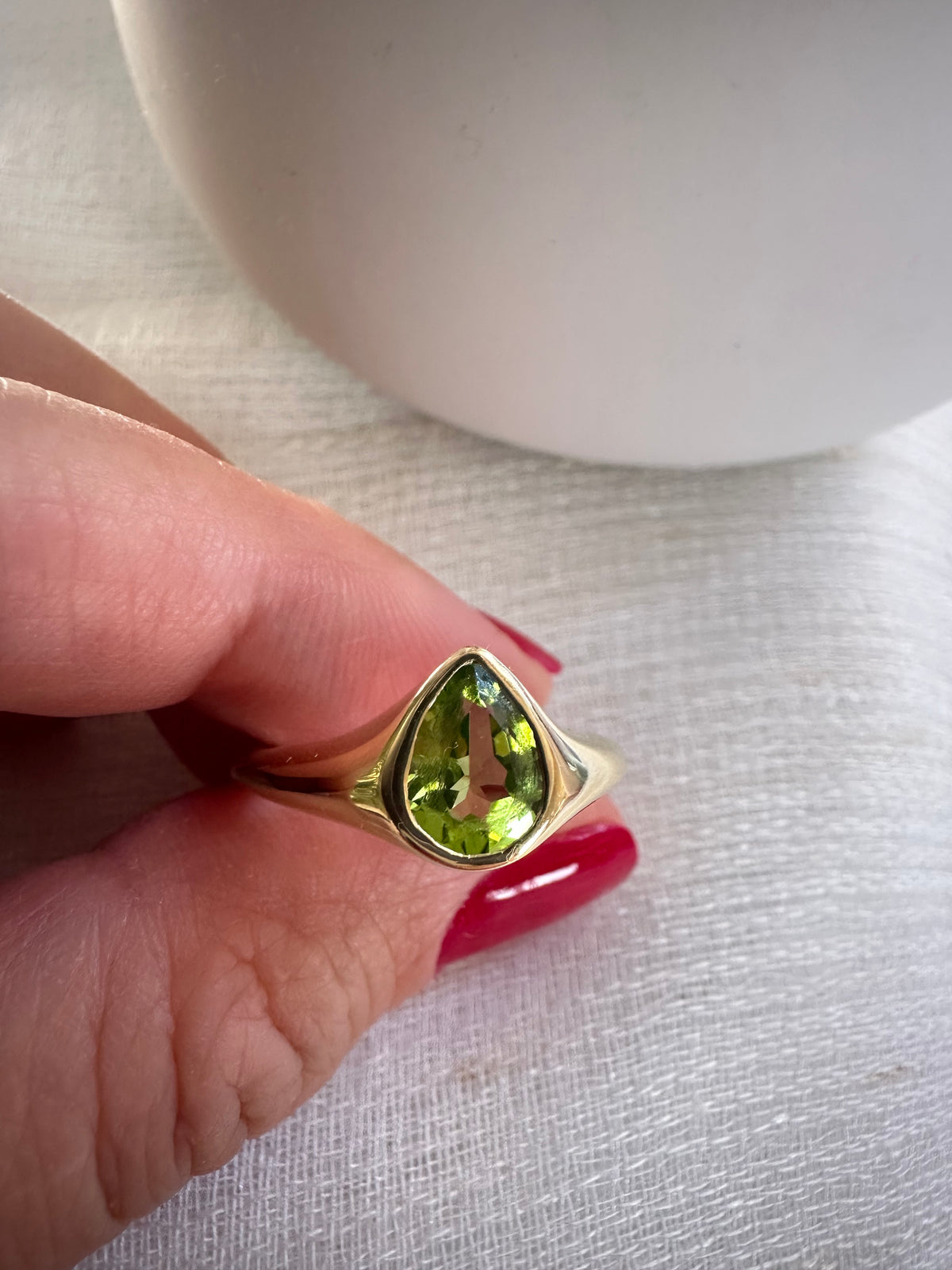 Modern signet ring with a 1.24 carat pear-cut peridot in an 18K gold bezel