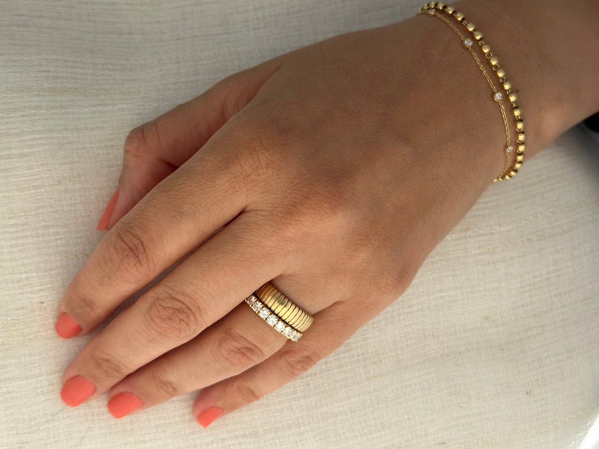 14K eternity band with a shared prong setting and a row of lab diamonds