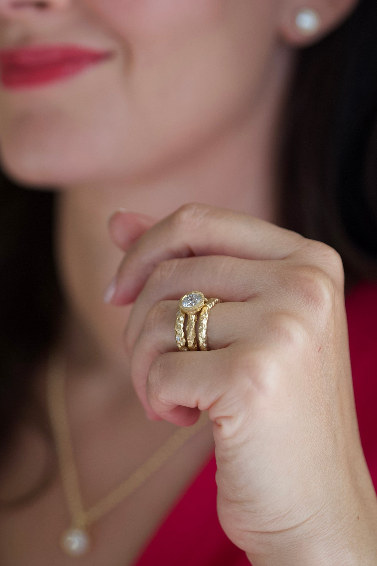 Glypto hammered gold band stacked with the Glypto Solitaire Ring, worn on a hand