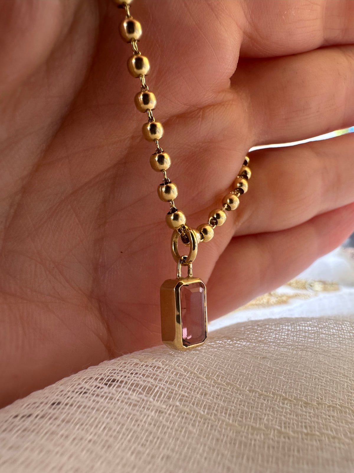 Second view of the 2 carat emerald cut pink tourmaline charm
