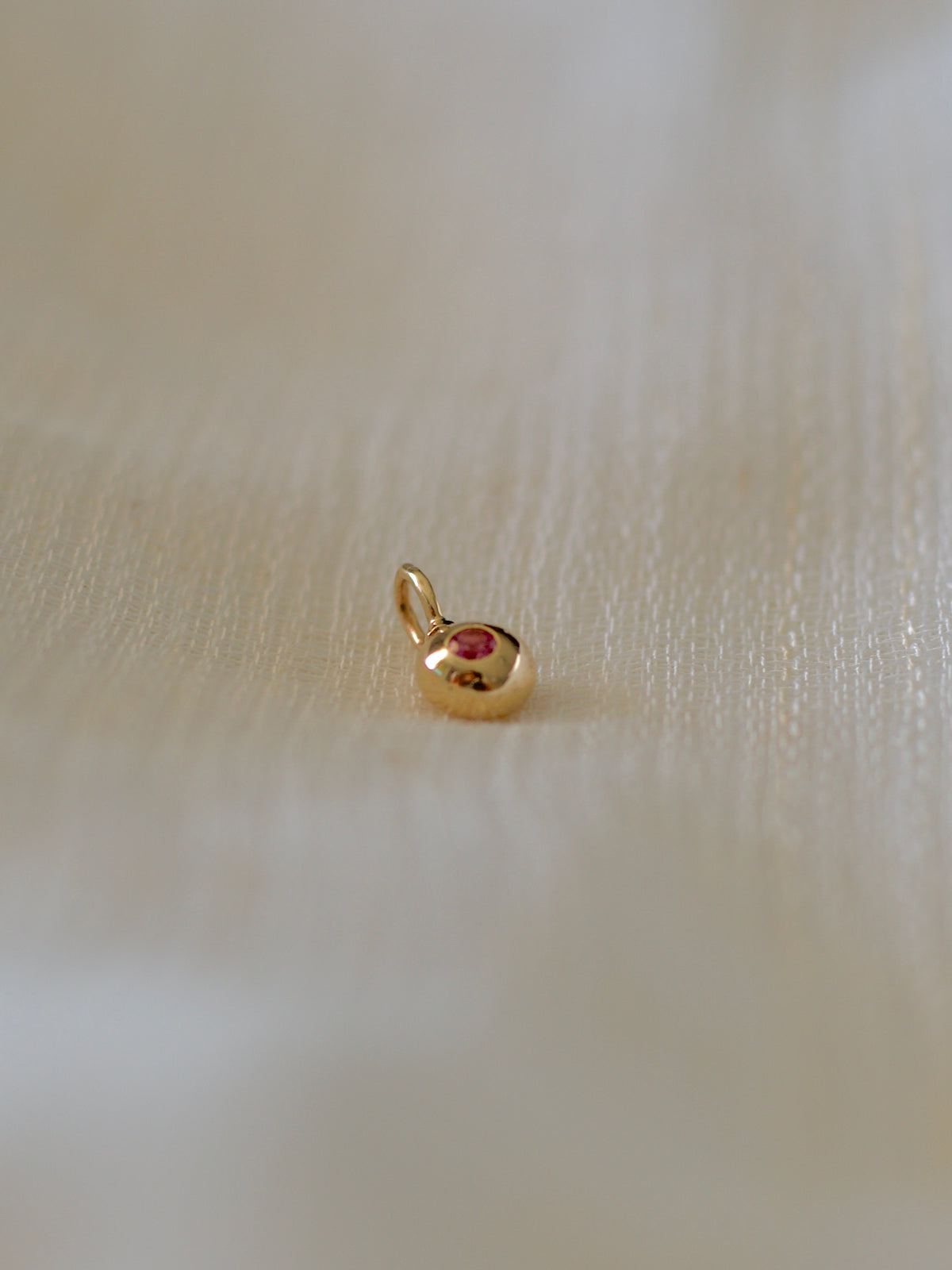 14K gold nugget charm with a pink sapphire and tsavorite, designed to wear either side | Yasmin Nabulsi Fine Jewelry