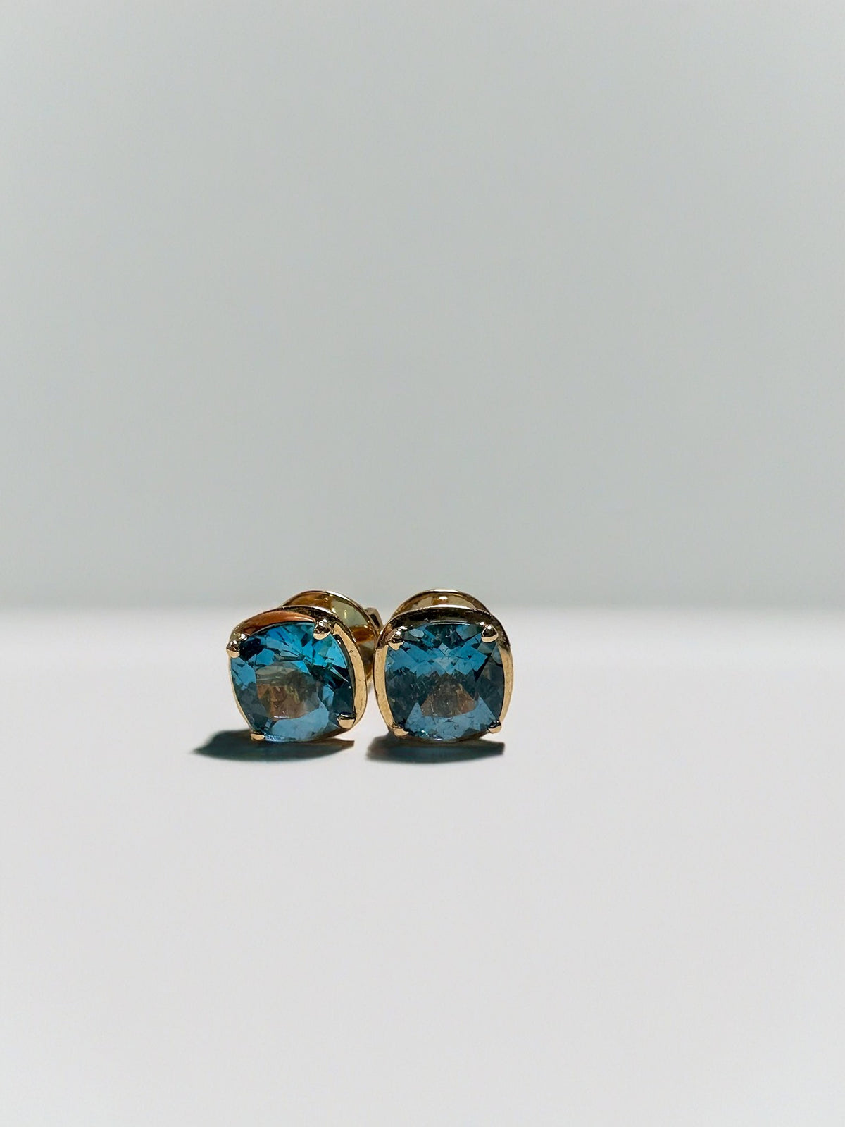 18K rose gold stud earrings with a cushion cut London blue topaz | Yasmin Nabulsi Fine Jewelry