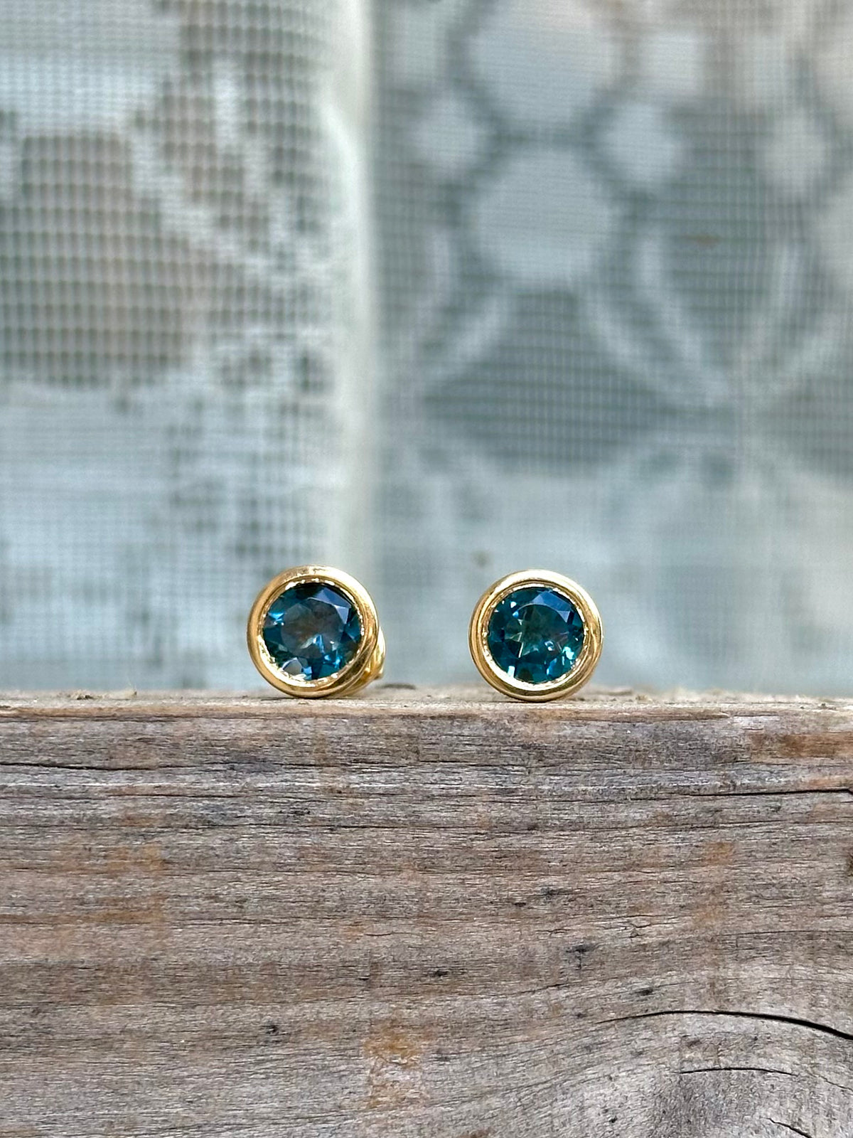 Blue topaz stud earrings with a thick bezel setting for everyday wear