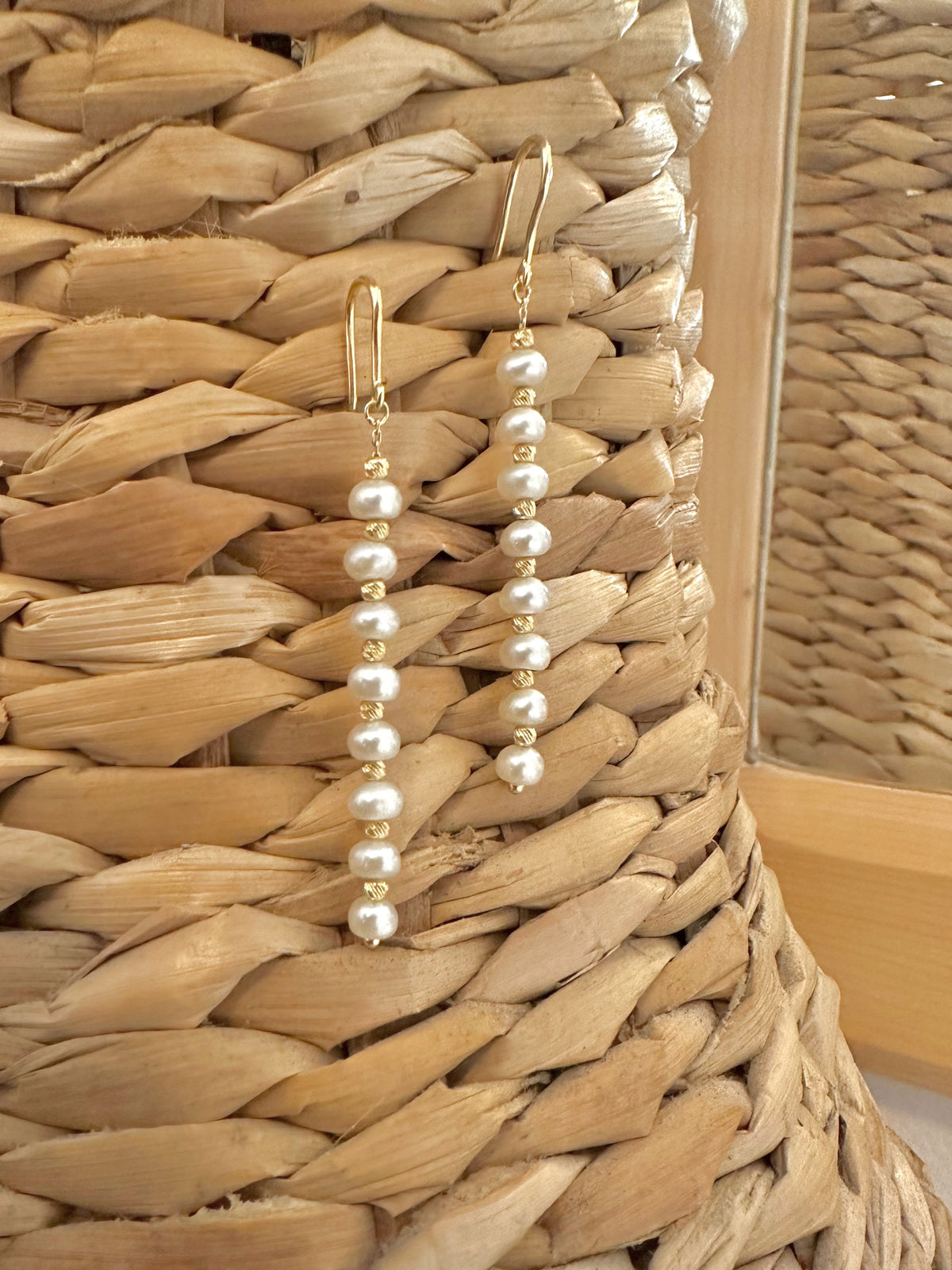 Gold pearl earrings with a secure hook closure