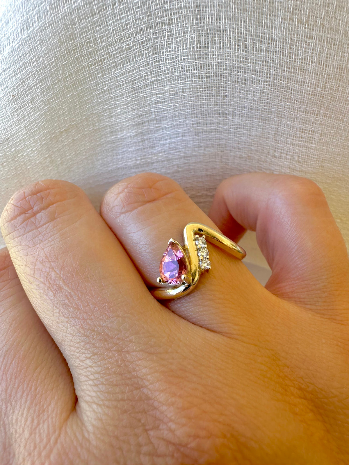 Wave ring in 14K gold with a prong set pear center, a different view