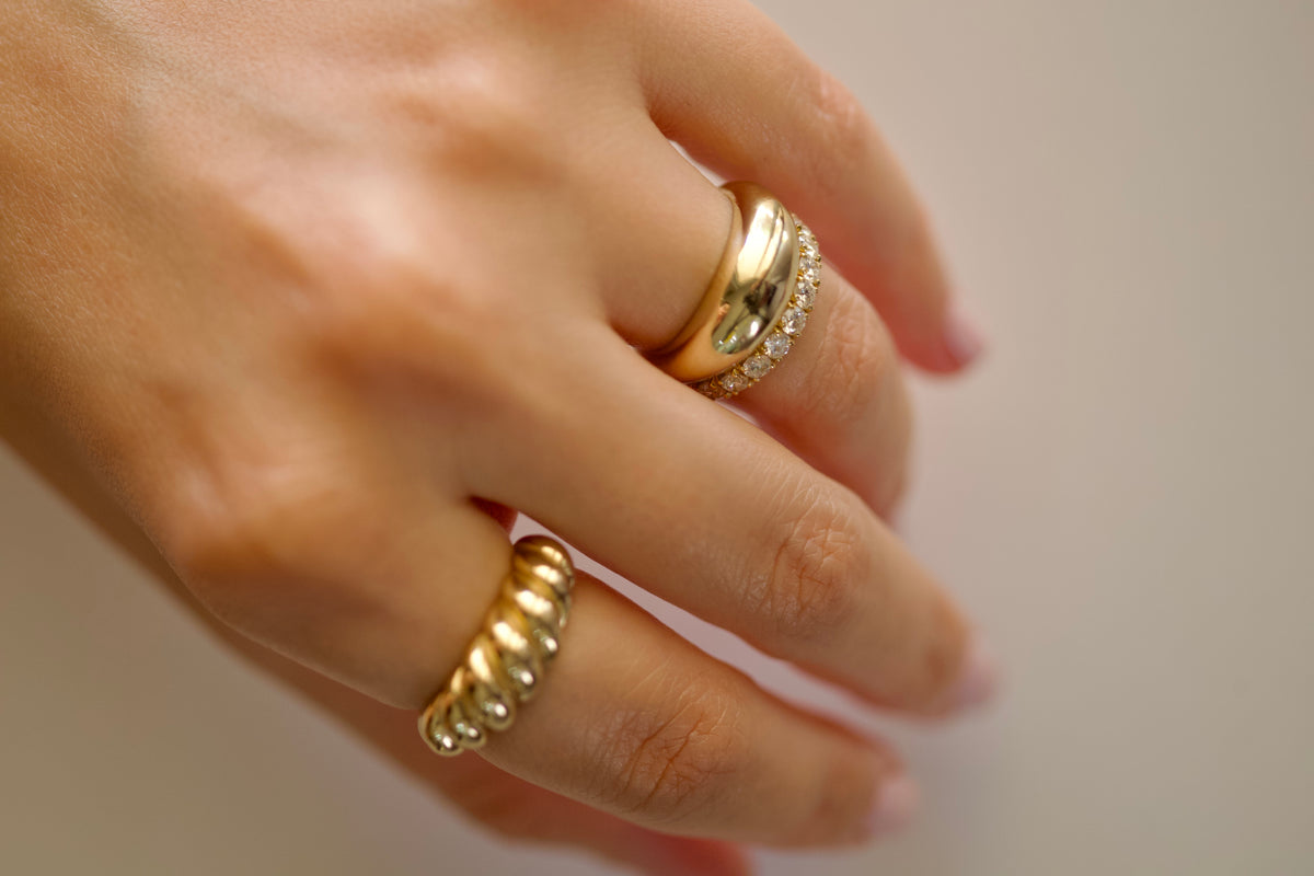 Close-up of the croissant ring's sculpted ridges and high polish finish