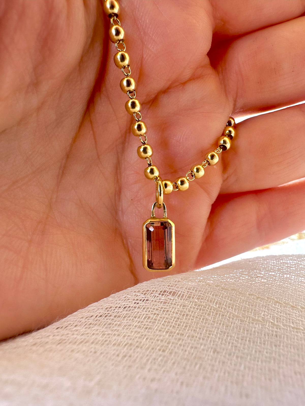 Emerald cut pink tourmaline charm in 18K gold | Yasmin Nabulsi Fine Jewelry