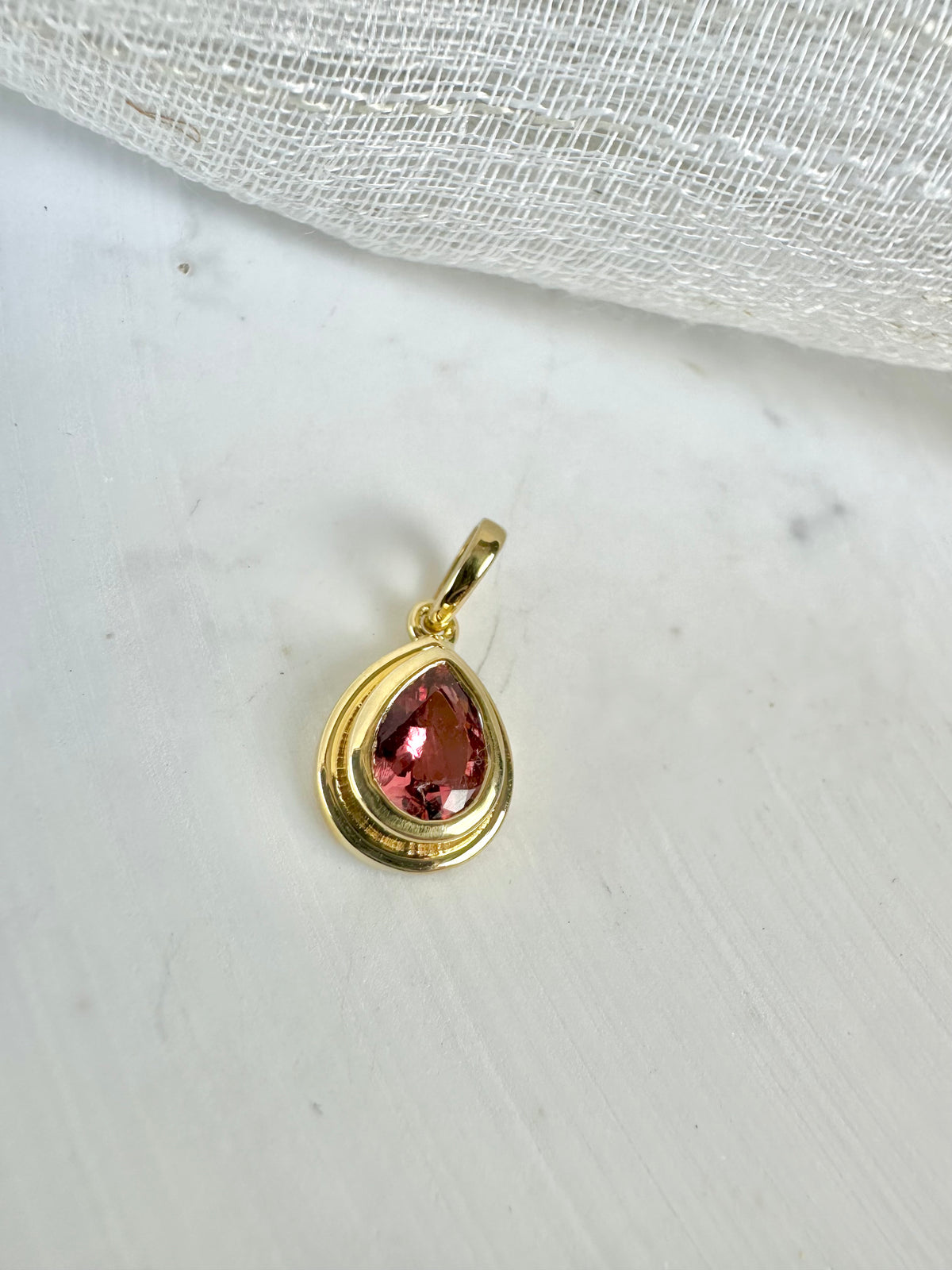 Pink tourmaline pendant, a 0.6 to 0.7 carat pear stone in gold