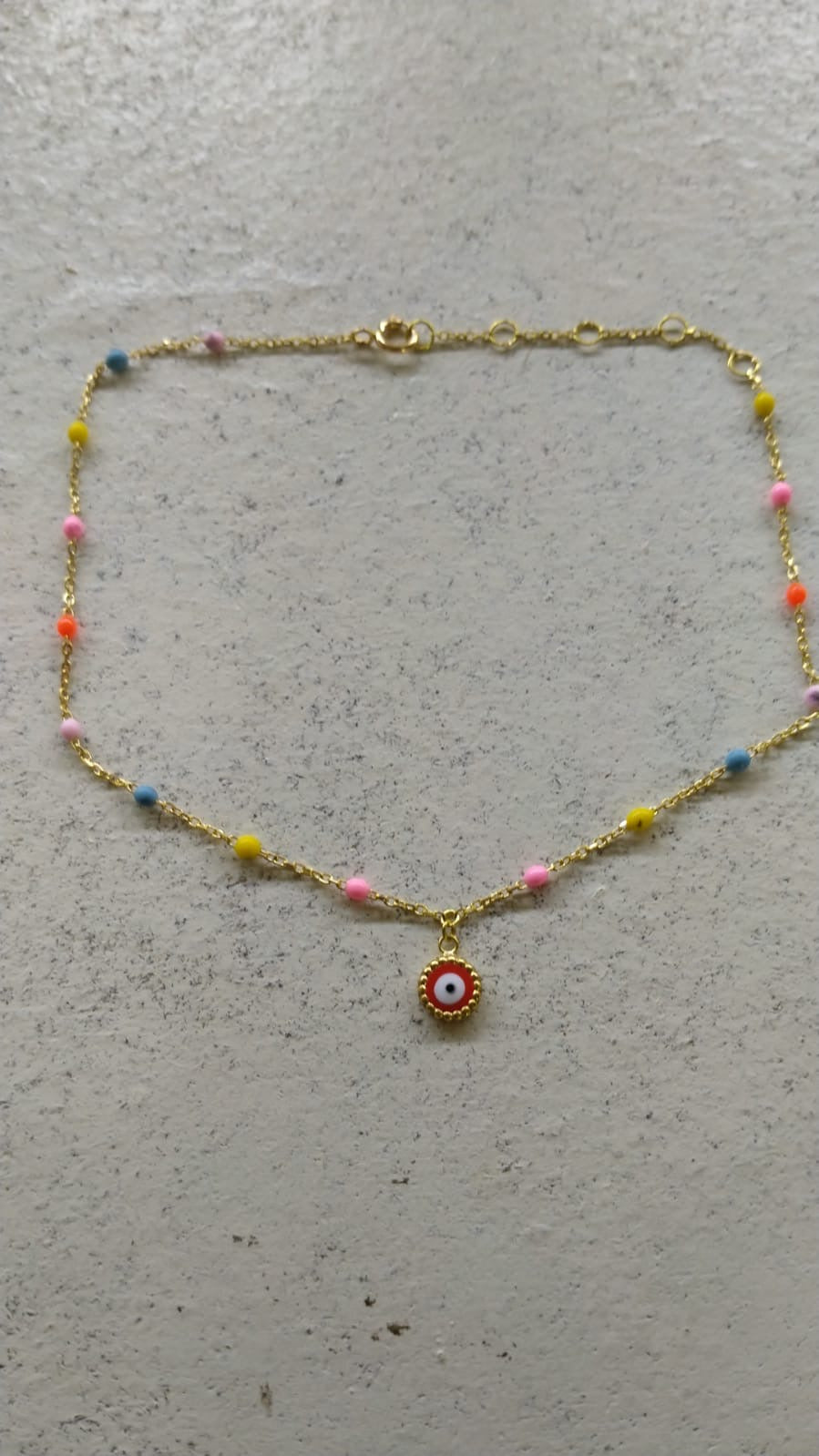 18K gold evil eye anklet with enamel points, shown from another angle