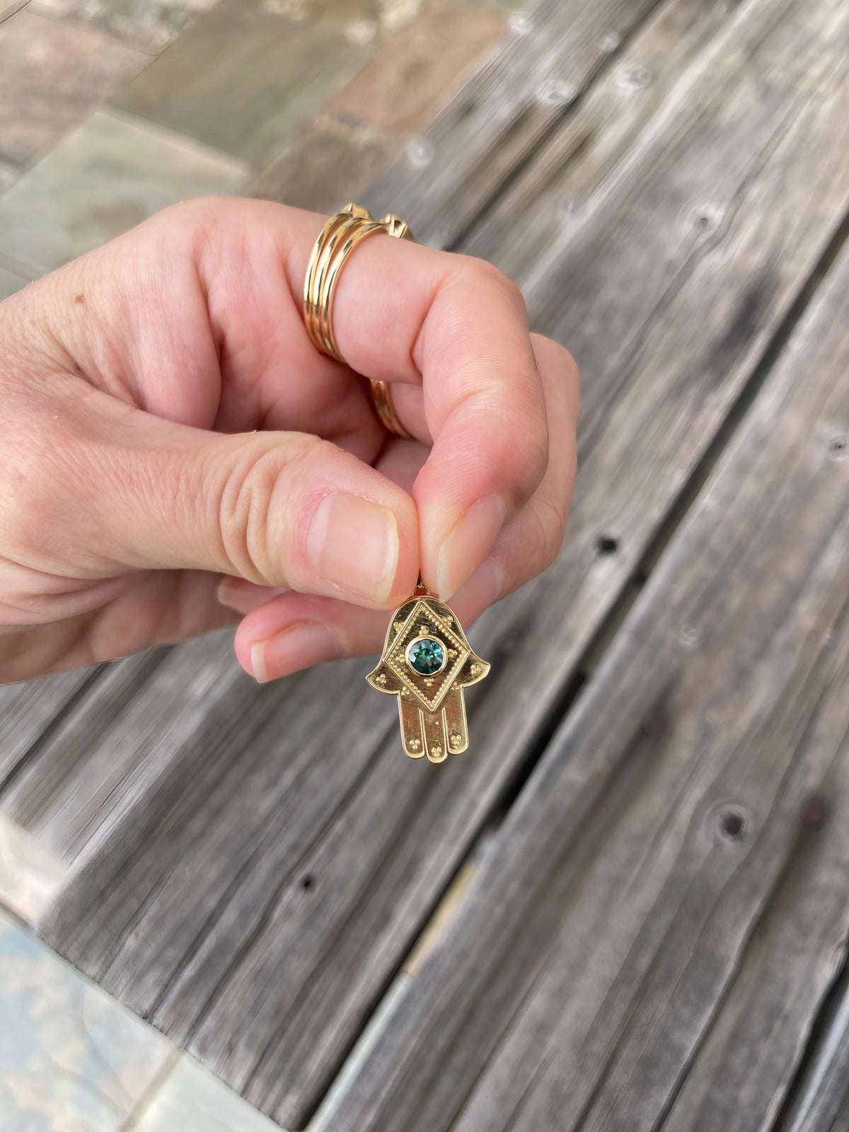 Gold hamsa hand pendant, which can be paired with any of the available chains